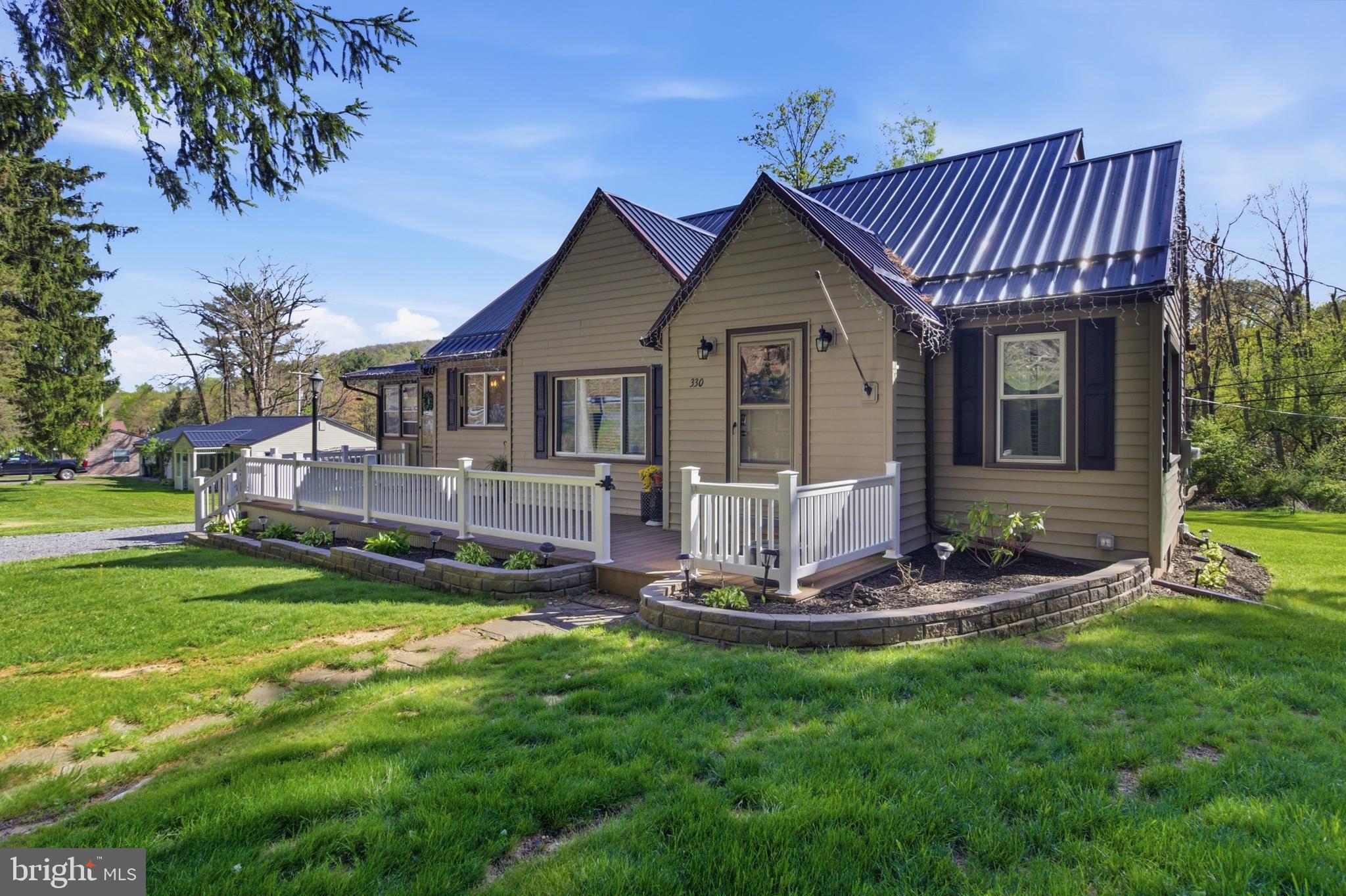 Welcome to 330 Flat Rock Road! An absolutely charming A-Frame Cape Cod that perfectly blends modern updates with timeless character, all set on a beautiful 1.6-acre lot in the Bald Eagle Area. Backing to a peaceful stream, you can enjoy lovely mountain views, soaring pine trees, and an expansive front porch - perfect for relaxing, taking in the scenery, and listening to the gentle sounds of the nearby water.

This one-of-a-kind home has been thoughtfully renovated from top to bottom while preserving its original charm. Since 2022, nearly every major system has been upgraded, including all new plumbing and electrical, a 200-amp service, new windows throughout, and all new light fixtures. Original wood floors run throughout the home and have been beautifully refinished, enhancing the home’s warm, inviting feel. The open floor plan offers easy, functional living while staying true to the home’s unique character.

The kitchen features all new appliances (2022), and the updated bathroom brings a fresh, modern touch that still fits seamlessly with the home’s style. Upstairs, plumbing has already been run for a potential second bathroom, making future expansion simple. Three bedrooms are currently in place,  along with added closet space for extra convenience.

Major exterior and mechanical upgrades include a new roof, heat pump, and central air system (2024), plus a new concrete patio built to support a hot tub, perfect for relaxing and enjoying the serene backyard setting. The property has also been enhanced with new landscaping, flower beds, grading (2023), a new shed (2023), and a water softener and filtration system.

The 1.6-acre lot offers endless possibilities with plenty of space to play, garden, or unwind, especially with the added bonus of scenic mountain views, mature pine trees, and the babbling of a nearby stream - creating a peaceful, private setting.

Conveniently located with quick access to 322 and I-99, you’re just 7 minutes to Geisinger and 12 minutes to Beaver Stadium.

Updated with intention and full of charm, this truly unique home is move-in ready and unlike anything else. A rare find you won’t want to miss.
Disclosure: Seller is a Licensed Realtor