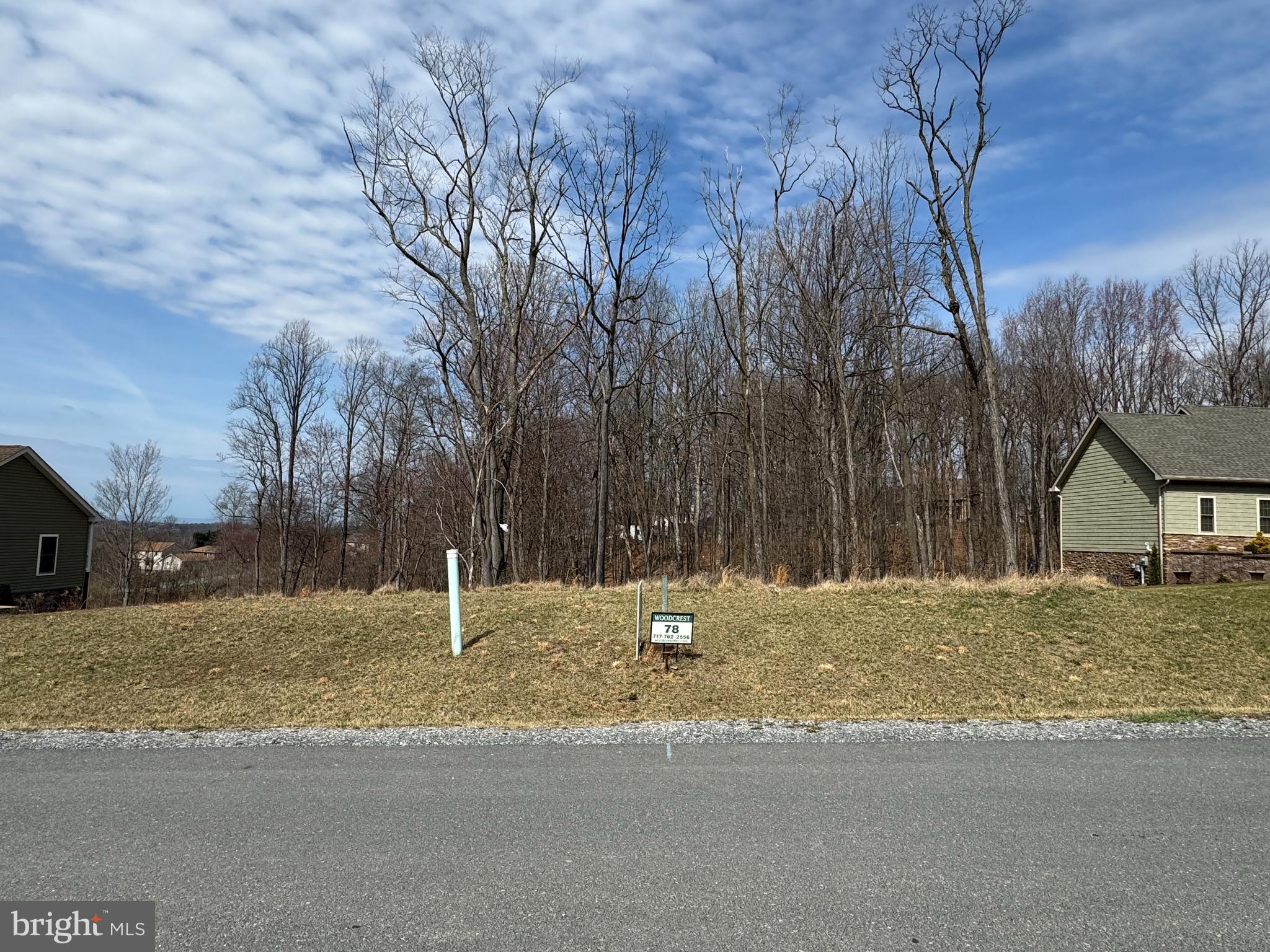 Lot 78 is one of only a few remaining lots on White Oak Dr.  This lot would be perfect for a rear walk-out level basement. White Oak is one of the final sections of distinctive Forest Hills. Located in the rolling hills of south-central Pennsylvania, this lot is ready for your dream home. This lot is builder restricted to Woodcrest Homes, Inc., a 100% custom builder, will offer you the very best in quality construction. Let them design and create your perfect home or assist with ideas on your preferred plan. 3D video and walk through tours are available of previously constructed homes. Only minutes from Maryland and approximately 90 minutes from both Baltimore and Washington D.C., this wooded homesite will be equipped with public water and sewer, as well as clean, efficient natural gas. Enjoy life in this quiet rural setting, surrounded by the Michaux State Forest and less than one-half mile from the Appalachian Trail. Multiple golf courses located within a half-hour drive, including The Waynesboro Country Club, a private, full amenities club, within minutes.  Also nearby, Ski Liberty and Whitetail Resorts - both owned by Vail Resorts.