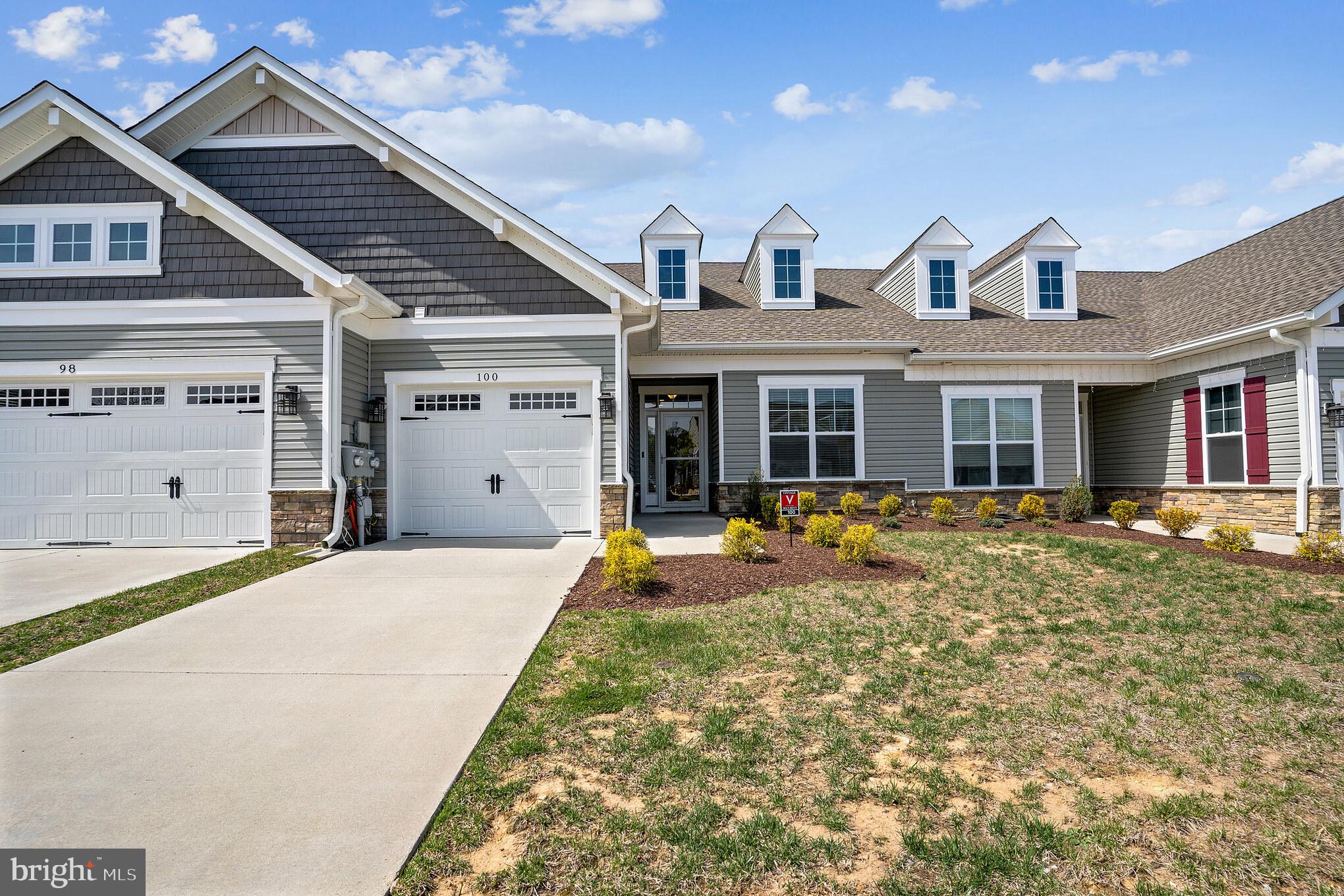 Located in a desirable 55+ community, this beautifully maintained home offers one-level, open-concept living with 2 bedrooms, 2 full bathrooms, and 9-foot ceilings. The spacious kitchen and dining area flow seamlessly into the family room, featuring an electric fireplace, and a bright sunroom.  The well-appointed kitchen includes a large granite island with breakfast bar seating for four, a deep double sink with a gooseneck pull-down faucet, tile backsplash, smooth-top range, built-in microwave, refrigerator with ice maker and water dispenser, and a pantry.  The family room features an electric fireplace with mantle and remote, and a ceiling fan. The adjoining sunroom, ideal as a home office or sitting room, is filled with natural light and provides access to the rear patio.  The spacious primary suite offers a ceiling fan, dressing area, walk-in closet, and an en-suite bath with a large walk-in shower featuring ceramic tile walls. The secondary bedroom is conveniently located adjacent to the second full bathroom.  Additional features include a mud/laundry room with a full-size washer and dryer, and a one-car attached garage with an automatic door opener and remotes.  Enjoy exceptional community amenities including a clubhouse, swimming pool, billiards room, fitness center, and walking trails.