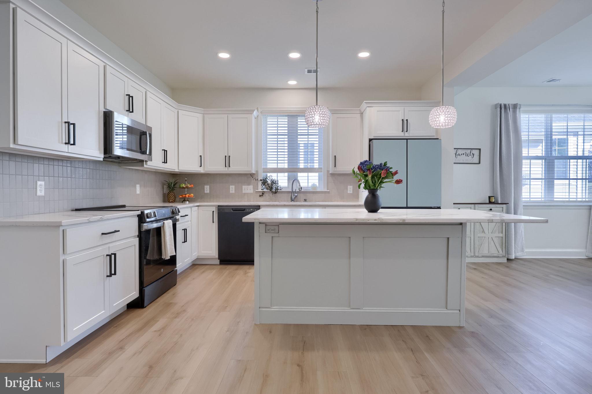 Newly built in 2024, this upgraded three bedroom, two and a half bath Cahill Model by Murry Homes offers comfortable, low-maintenance living in Millersville’s lovely Bellaride at Crossgates community. This beautiful home showcases a bright open floor plan with luxury vinyl plank flooring, updated lighting, quartz countertops, and abundant natural light throughout. The kitchen is a perfect place for entertaining, featuring Calacatta quartz countertops, large island, stainless steel GE appliances, Samsung Bespoke refrigerator, and updated hardware. The kitchen opens to the dining area and living room with a gas fireplace featuring a Kenwood mantel, along with sliding glass doors that lead to the outdoor patio—an inviting space for all your entertainment needs or simply relaxing. The main level primary suite provides a private retreat featuring a walk-in closet and ensuite bath featuring double vanity, tiled walk-in shower, and a decorative beadboard accent wall. The upper level includes a spacious second family room with a large walk-in closet for additional storage needs, a bonus flex space with vaulted ceilings, two additional bedrooms with carpet floors and double door closets, and a full bath. Additional highlights include main level laundry, window treatments throughout and a two-car garage with storage space. Located within the Crossgates HOA, which covers lawn care and snow removal. Convenient to Crossgates Golf Club, Millersville University, walking trails, shopping, and dining. Schedule your showing today!