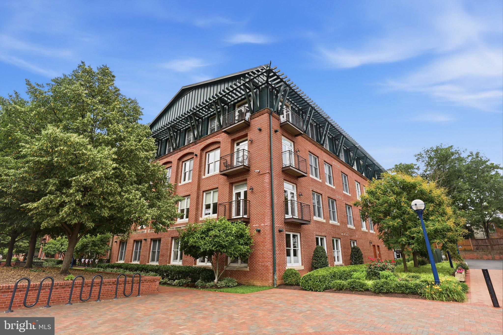 LIMITED AVAILABILITY CREEK FRONT CORNER UNIT at the exclusive Maxwell Place Condominiums.  This building continues to stand as downtown Frederick's premier condo living.  Located directly on Frederick's award winning Carroll Creek, this unit spares no expense.  Creek front and corner unit for all the windows and maximum visibility and views.  This condo runs along the west side of the building and has westerly and northern views.  From a floorplan perspective, this unit is one of the most desirable.  This two bedroom two full bath plus DEN make it a supremely usable space.  Enter the unit to the den area.  Use as an office, sitting room, library, foyer.  It's yours to imagine how you would use the space.  Continuing down the hallway you come to the guest bedroom complete with two closets, creek views and a contemporary flair.  The hall bath has been renovated with classic appeal.  Carrara marble tile on the floor and in the shower will stay timeless for years to come.  The laundry/utility closet offers supreme smart storage solutions.  The primary bedroom is a jewel with a newly renovated full bath with dual sinks, high vanity with oversized mirror, and walk-in shower with frameless glass surround.  The primary bedroom is oversized with ample room for even the largest bedroom set.  The primary also features a walk-in closet with custom built-in closet system.  Opening up to the show stopper of the home is the kitchen/dining/living areas.  The kitchen offers a gorgeous Cafe appliance package, new backsplash, granite counters, gorgeous wood cabinets, and wood floors.  The eat-in breakfast bar flows from the kitchen into the dining room.  With walls to support your china cabinet, this area is huge and can accommodate even the largest dining table.  The living room area is the heart of the home showing off its creek views and dual balconies with roller screens and replacement doors.  The space is deceivingly large and can be laid out so many different ways.  This unit conveys with two parking spaces in the secure parking garage, and an assigned storage cage.  The building has two elevators, secured entry, and intercom system.  Enjoy the view of the boats in the creek in the winter, join the salsa classes under the stars, walk to bars and restaurants, the library, bakeries and theaters.  You will not be disappointed in this unit or the lifestyle it provides.