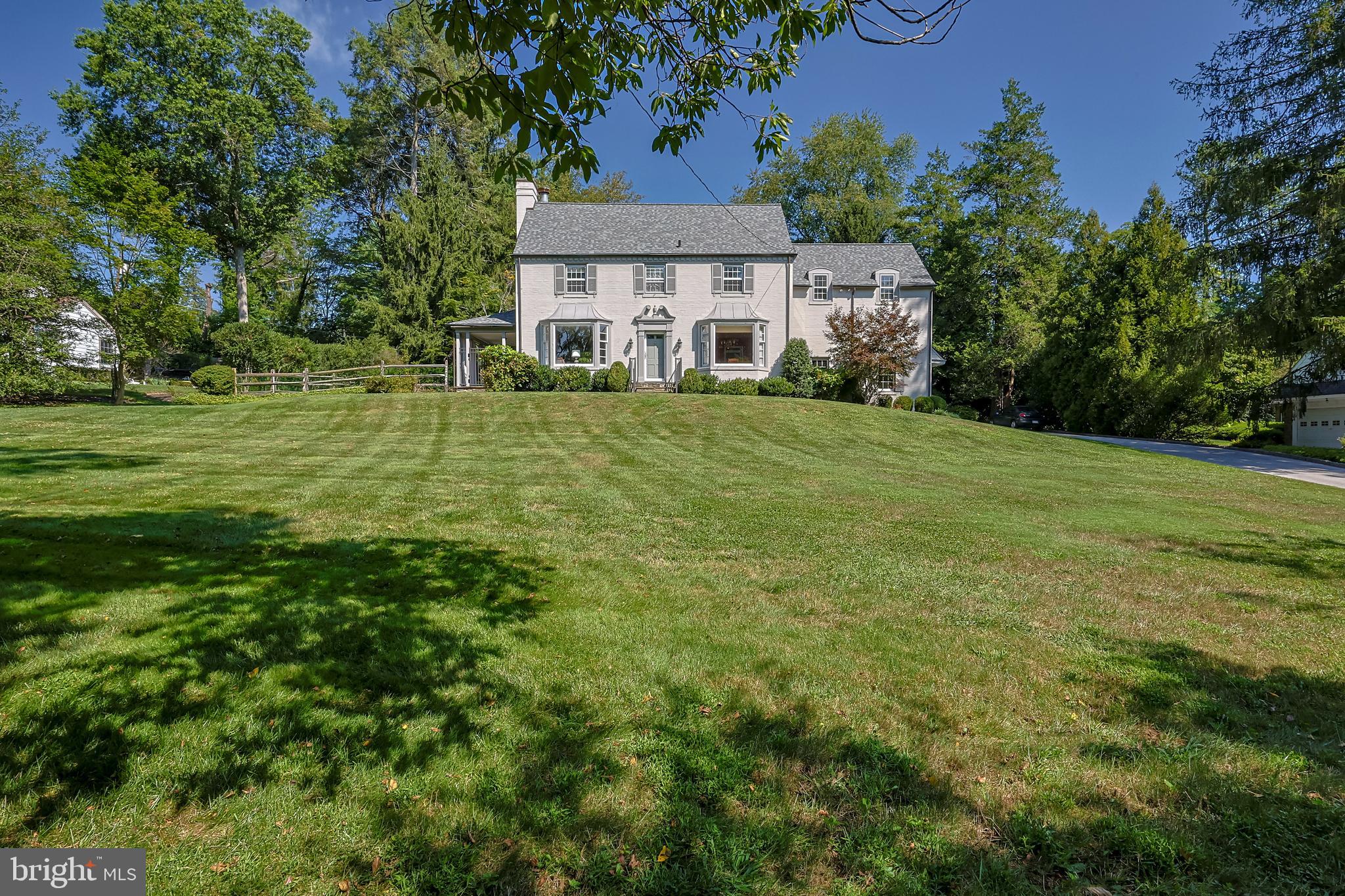 It doesn't get more classic than a stately center hall Colonial and that is exactly what this beautiful home is!  A classic!  Set on a picturesque lot in beautiful Penn Valley, Lower Merion is this truly loved 4 bedroom 3 full and 1 half bath home.  Enjoy endless hours of peace and tranquility in the backyard oasis.  A beautiful pool, hot tub and plenty of outdoor entertainment space with a large flagstone patio offers you, your family and guests a truly special place to enjoy 3 seasons a year.  The first floor of this home has a great flow and living space.  The center hall foyer connects all the spaces.  A large and sunlit living room with a bay window, fireplace with marble surround and a french door leads you out to the side porch.  The dining room, perfect in size also has a bay window with a beautiful nature filled view.  The kitchen is large with ample counter space, oak cabinets with crown molding detail, recessed lighting, walk in pantry and a large center island. Directly off the kitchen is a gorgeous great room with vaulted ceiling, fireplace with floor to ceiling brick detail, recessed lighting and oversized windows.  The great room has plenty of space for a large dining table as well.  Double french doors lead you out to the backyard and they give you year round natural light and a view of your gorgeous property.  The kitchen and great room have a terracotta floor tile which flows nicely off the oak hardwoods in the rest of the first floor.  Perfectly tucked off the center hall is a classy powder room with a custom vanity, offering open shelving and cabinet/drawer storage.  The mud/laundry room is on the left, right as you walk in off the driveway side door.  The 2nd floor has a large primary suite with 2 closets (1 which is a  walk- in), a fireplace and a recently renovated bath.  Carrera tile for the win!  This bathroom is light and bright with beautiful tilework and a nice deep linen closet.    There are 2 more bedrooms and a full bath off the main hallway, all with great closet space and a 4th bedroom with an en suite bathroom.  If needed, this space would be great for an au pair, in-law or house guest.  The original back staircase is still operational and connects from the kitchen up to this more private 2nd floor living space.  This home offers so much space with its amazing floor plan, square footage and room sizes.  The walk up attic is incredible for additional storage!  The basement is currently unfinished (but could easily be finished!) and connects to the interior access garage.  The location cannot be beat!  Perfectly perched on a beautiful lot with mature landscaping and accessible to all things Main Line and Narberth Boro!  Award winning Lower Merion schools, shopping, dining, beautiful scenery at every turn- this home has it all.
