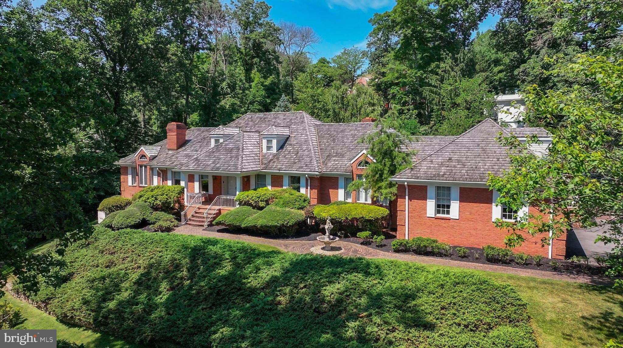 Welcome to 21 Springton Pointe Drive! A beautiful custom-built home including four bedrooms and eight bathrooms with over 5,300 sq. ft. of above-grade-level living space. This home is truly one of a kind with views of Springton Reservoir.  Upon entering you are greeted by a grand foyer adorned with marble flooring and a sweeping curved staircase leading to the second floor. The main floor boasts a blend of comfort and spaciousness as this open floor plan is truly like no other.  A wide center hallway runs the length of the house offering access to the kitchen, family room, dining room, foyer, living room, study, and primary bedroom.  The first-floor living space includes a large eat-in kitchen featuring granite countertops, custom cabinetry, a Sub Zero refrigerator and freezer, a spacious center island, and upgraded appliances. Just off the kitchen is a powder room, a large pantry, and a sunroom bathed in natural light, which leads to the outdoor patio and pool area.  The family room and living room are both adorned with fireplaces creating a warm and cozy ambiance.   The grand formal dining room is perfect for hosting memorable family gatherings.  Just off the foyer is a formal powder room and a bedroom with a private bathroom. Currently, this bedroom is being used as a study/home office and features hardwood flooring and built-in bookshelves. Lastly, wrapping this enormous first floor up is the primary bedroom. This bedroom consists of a large sitting area, wet bar, gas fireplace, and laundry room. The huge primary bathroom features a steam shower, a large jetted soaking tub, his and hers vanity and toiletry areas, and a generous walk-in closet with built-in storage cabinetry. Upstairs, discover two large bedrooms connected by a Jack and Jill bathroom and a cozy sitting area loft, making a perfect retreat for relaxation or reading.  The walkout lower level consists of approximately 4,300 sq. ft. of additional square footage with more than half of it being finished.  The finished area includes a second kitchen, a bar, a fireplace and plenty of room for entertaining.  In addition, there are separate men's and ladies' bathrooms and a large wine cellar.  The unfinished area includes plenty of room for storage, including storage shelving, a cedar closet, another washer & dryer, a utility sink and stairs to the oversized heated three-car garage.  This home's outdoor space is perfect for entertaining around the pool with mature landscaping, brick patios, a pool house with a full bathroom, a gazebo and plenty of privacy.  Come and enjoy living in this prestigious neighborhood located within the award-winning Marple-Newtown School District and to some of the best private schools.  Located just a quick drive to Media Borough, West Chester and the Main Line, all having an impressive array of upscale restaurants, shopping and entertainment.  Now is your chance to be only the second owner of this impressive custom built home by a local real estate developer and builder.