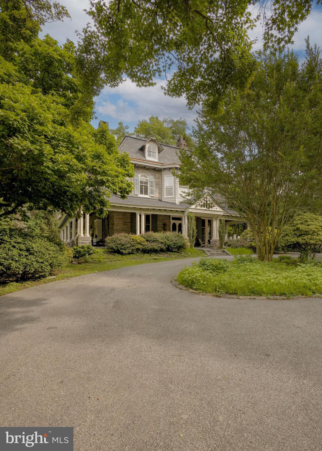 Welcome to 42 Summit Street, where a handsome stone wall and circular driveway greet you. Designed in an Italianate/Second Empire style circa 1863 by renowned surveyor and architect J.C. Sidney, this home was occupied by the prominent Heebner family of Chestnut Hill for 74 years. A significant 1887 upgrade introduced its glorious wraparound porch, inlaid and parquet flooring, summer kitchen/butler's pantry, and main bedroom suite. Countless original details remain, making this a home that unfolds before your eyes.
Historic significance meets everyday livability, thanks to a thoughtful layout and an array of recent restoration. Over the past year, the current owners have invested deeply in the home's systems and finishes: completely updated electric, a brand-new septic system, a complete roof replacement, fresh interior paint throughout, and custom millwork that honors the home's craftsmanship. For peace of mind, both asbestos and radon remediation have been professionally completed.
The home offers 11-foot ceilings, multiple fireplaces, and central air. The first floor features a large living room, sitting room, proper dining room, a powder room with a 17th-century sink from Italy, and an expanded kitchen. The 2016 renovation enlarged the footprint, painstakingly restored original cabinetry, and added new cabinets, Thermador and SubZero appliances, and stunning soapstone countertops and sink.
Climb the beautifully carved staircase to the second floor and the main bedroom suite, appointed with custom-painted French doors and antique elements including Belgian paving tiles and decorative shower tiles. Three more well-sized bedrooms, a brand-new second-floor bathroom, and an additional full bath complete this level. The third floor offers three more bedrooms and a full bath with a cast-iron clawfoot tub—ideal for a home office, nanny suite, or guest quarters.
Outdoor space abounds, with a flat side yard and a lovely backyard featuring a brick patio made for grilling. Mature plantings include tulip magnolia, blue wisteria, and Japanese maple. You're 30 minutes to downtown Philadelphia, or just two turns to Route 309 toward Trenton and the Amtrak to NYC. Steps from everything Chestnut Hill offers—boutique shopping, fine dining, street festivals, the Farmers Market, Wissahickon Valley Park, and both Chestnut Hill West and East Regional Rail lines.
A walkable and sublime lifestyle in every way. Don't miss your chance to live the life on Summit Street!