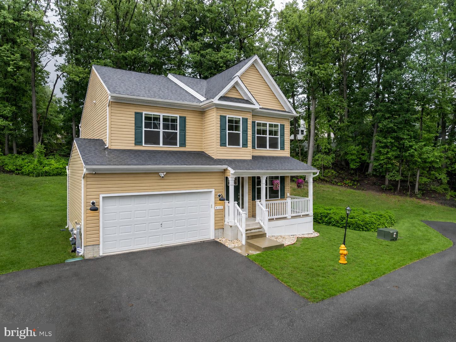 Welcome to 9111 Verdant Way in Sommerville Estates, Elkridge. Step onto the beautiful composite-covered porch and immediately feel the curb appeal. Inside, fresh LVP flooring flows throughout the main level, leading you through bright, thoughtfully designed spaces. Four bedrooms upstairs with two full bathrooms give you room and flexibility. Downstairs, the fully finished basement opens up even more possibilities — a den, a recreation area, and a full bathroom create a separate retreat perfect for a playroom or a home office. Built in 2021 and featuring approximately 3,098 sq ft of finished living space, this home is move-in ready and built to last. Parking is abundant with a two-car garage, driveway parking for two more vehicles, plus additional side parking. And the setting? Surrounded by mature trees, the home feels wonderfully settled and peaceful. Location is everything. You're minutes from Arundel Mills, with easy access to Route 100 and I-95 for quick commutes to Baltimore, Washington, D.C., and the airport. Howard County's top-rated schools serve this area. Historic Ellicott City and the Thomas Viaduct are nearby, along with Patapsco Valley State Park for outdoor adventure. This is a rare newer build with serious substance and location. This is the one!