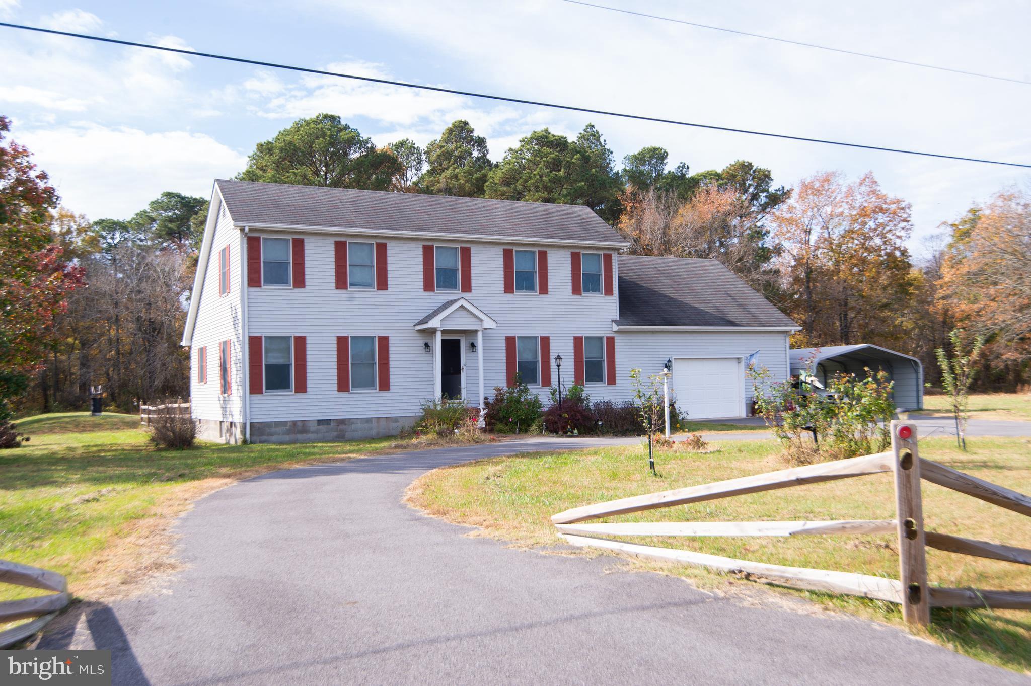 This lovely home in the country is waiting for you!  Large clear lot backs to woods.  It offers a garage with additional storage, carport and large shed with electric.  An open first floor including kitchen with plenty of cabinets and counters and an island.  All appliances included.  Large sunroom with a cozy pellet stove opens to back deck. Primary bedroom with attached bath on first floor.  Two additional bedroooms on second floor as well as another bath.   Storage is easily accessible from the upstairs bedrooms. There is also another full bath off the laundry/mudroom which is just off the garage entrance.  Back yard has fenced area for children or pets and even a chicken coop!