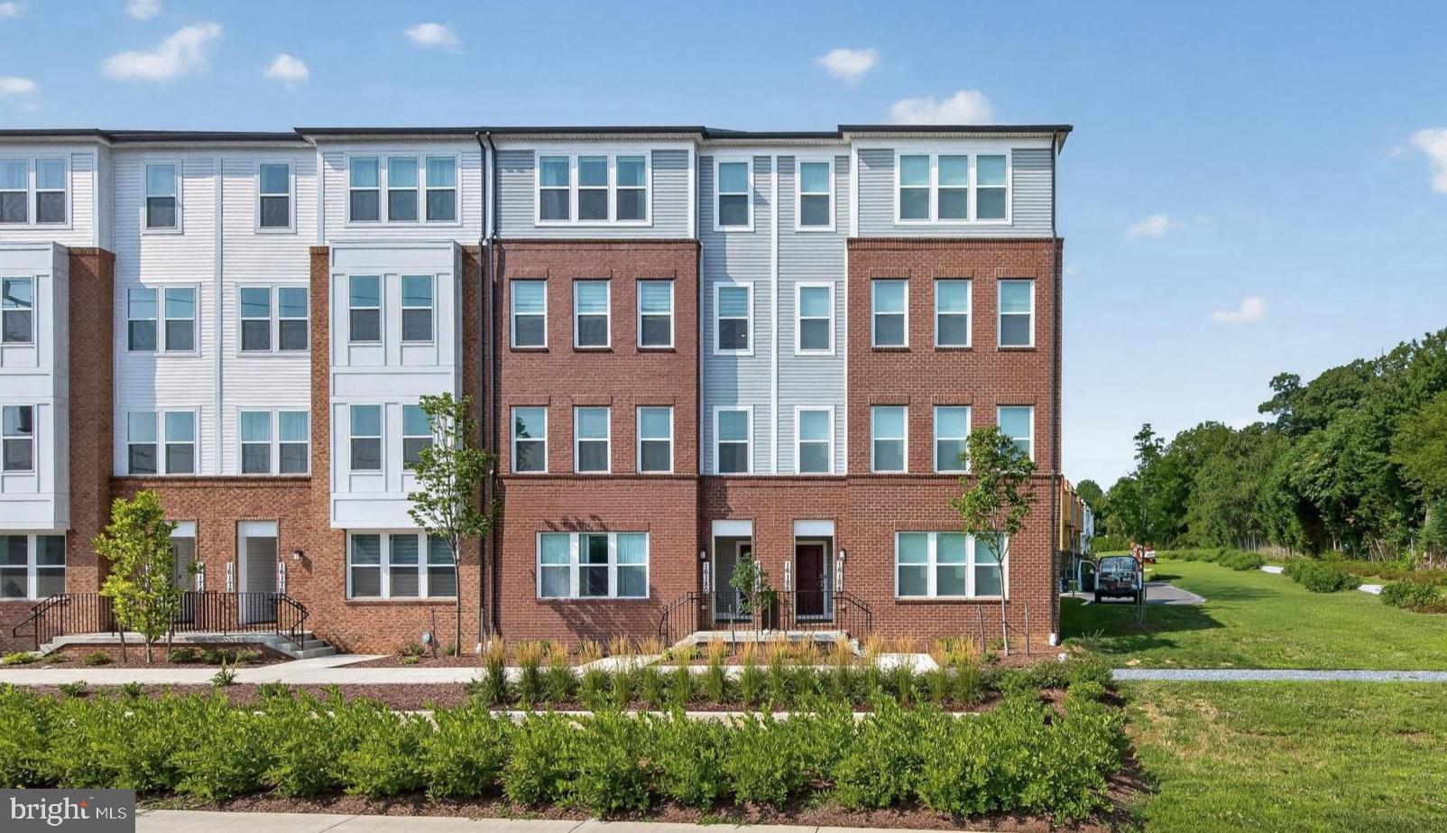 GREAT LOCATION MEETS LUXURY!!  Rare, like new, stunning home just one year young and in perfect move in condition. Loaded with premium upgrades throughout, this exceptional Pulte-built end unit townhouse offers 3 BR's and 2.5 Baths with attached garage. Providing the perfect blend of modern style, comfort, and convenience. The main level is thoughtfully designed with spacious open-concept living areas that flow seamlessly into the gourmet kitchen. The chef's kitchen features a gas cooktop with a stylish range hood, stainless steel appliances, wall oven with built-in microwave, pantry, upgraded cabinetry, upgraded backsplash, and premium countertops. A convenient coat closet and powder room complete the main level. Upstairs, the primary suite has two walk-in closets and offers a private ensuite bathroom with walk-in shower, dual vanities and serves as a relaxing retreat. Relax in the morning on the private balcony off the primary suite. Two additional bedrooms share a spacious hall bathroom with dual vanities, offering comfort and convenience for guests. Upgrades throughout, including hardwood flooring, upgraded countertops, recessed lighting, enhanced cabinetry, upgraded tile in the bathrooms, upgraded fixtures, and a gas cooktop. Special noise-reducing front-facing windows provide a peaceful and quiet interior environment. LOCATION IS KEY, and this home delivers! Residents enjoy access to outstanding community amenities, including a clubhouse, swimming pool, fitness center, and other neighborhood amenities designed to enhance an active and connected lifestyle. Conveniently situated near major commuter routes including I-270, the ICC (MD-200), Metro stations, and Metrobus service, this location offers seamless access throughout the region. Everyday conveniences are just moments away, including MOM's Organic Market, a variety of restaurants, shopping destinations, entertainment options, and other local amenities. Hurry, this rare, like new Lawrence model won't last. A true 10+!