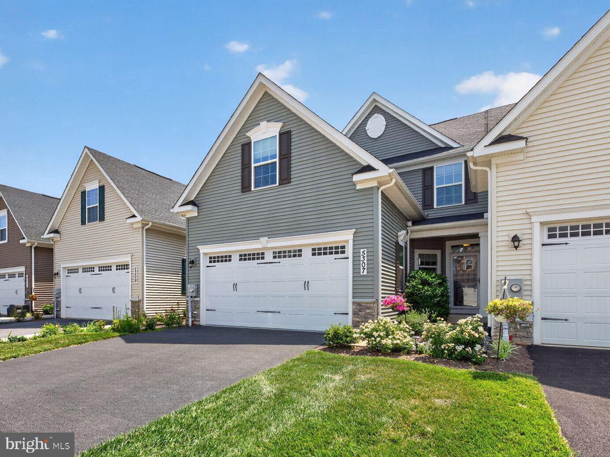 Enjoy the best of low-maintenance, active adult living in this beautifully upgraded and meticulously maintained 3-bedroom, 3.5-bath villa in Frederick's highly desirable Ballenger Run 55+ community. Offering approximately 2,700 square feet of finished living space, this thoughtfully designed floor plan combines the convenience of a main-level primary suite with private guest accommodations upstairs and an expansive finished lower level—creating a home that's equally suited for everyday comfort and effortless entertaining.
The open-concept main level is filled with natural light and showcases luxury vinyl plank flooring, a spacious living room with an expanded sunroom extension, and a generous dining area that flows seamlessly into the well-appointed kitchen. Featuring granite countertops, stainless steel appliances, a subway tile backsplash, pantry, abundant cabinetry, and an oversized peninsula with seating, the kitchen is perfectly designed for both casual meals and entertaining. Just off the living room, French doors open to a professionally designed paver patio with sitting walls, privacy fencing, and mature landscaping, creating a seamless indoor-outdoor living experience.
Privately tucked away, the main-level primary suite offers a spacious walk-in closet and an en-suite bath with a double vanity and oversized walk-in shower. A convenient laundry room, powder room, and oversized two-car garage with an epoxy-coated floor complete the main level.
Upstairs, you'll find two generously sized bedrooms, a full bath, and additional closet space, providing comfortable accommodations for family and guests while also offering the flexibility for a home office, hobby room, or dedicated space for visiting grandchildren.
The finished lower level significantly expands the home's living space with a sprawling recreation room offering endless possibilities for entertaining, a media room, fitness area, hobbies, or multiple gathering spaces. With a full bath and egress window already in place, there is the flexibility to add a fourth bedroom in the future if desired, while still maintaining generous unfinished storage space.
Ideally located in the sought-after Ballenger Run community, residents enjoy exceptional amenities including a resort-style outdoor pool, fitness center, clubhouse, and gathering spaces for social events and private functions. The home is also just minutes from Downtown Frederick, Westview Promenade, Ballenger Creek Park, I-270, shopping, dining, and everyday conveniences.
With its outstanding condition, extensive upgrades, versatile floor plan, and approximately 2,700 square feet of finished living space, this is one of Ballenger Run's finest offerings.