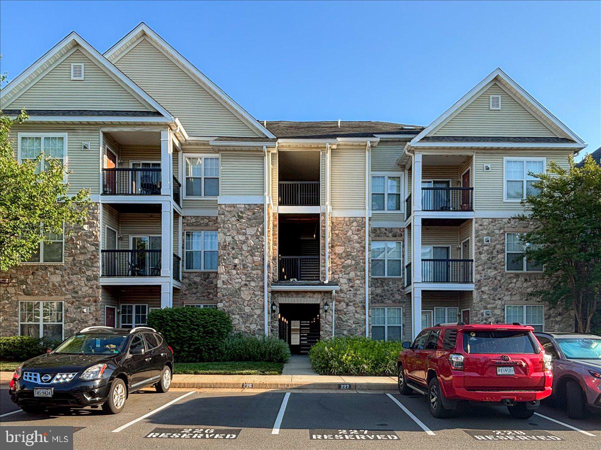 Welcome to this beautifully maintained 2-bedroom, 2-bathroom condo in the desirable gated community of Stonegate at Faircrest. This spacious home offers a bright and comfortable layout with abundant natural light, fresh paint, and new flooring throughout the entire unit. The updated kitchen features elegant granite countertops, maple cabinets, a new stove installed in 2026, a dishwasher replaced in 2024, a refrigerator that is only a few years old, and an exhaust fan replaced in 2022. Additional improvements include new bathroom vanities, mirrors, accessories, and light fixtures, along with replaced hinges and door handles throughout the home. The HVAC system was replaced in 2017, adding peace of mind for the next owner. Stonegate at Faircrest offers a wonderful lifestyle with community amenities that include an outdoor swimming pool, fitness center, and clubhouse. A dedicated parking space is also included for added convenience. The location is excellent, just minutes from Fair Lakes with easy access to I-66, Routes 29, 50, and 28, as well as Fairfax County Parkway. Nearby Metro bus service to the Vienna Metro station makes commuting even more convenient. Enjoy the ease of first-floor living in this gated community, a valuable feature for buyers seeking convenient access without navigating multiple flights of stairs. With its tasteful updates, desirable amenities, dedicated parking, and prime location near shopping, dining, and major commuter routes, this condo offers an ideal combination of comfort, convenience, and value.