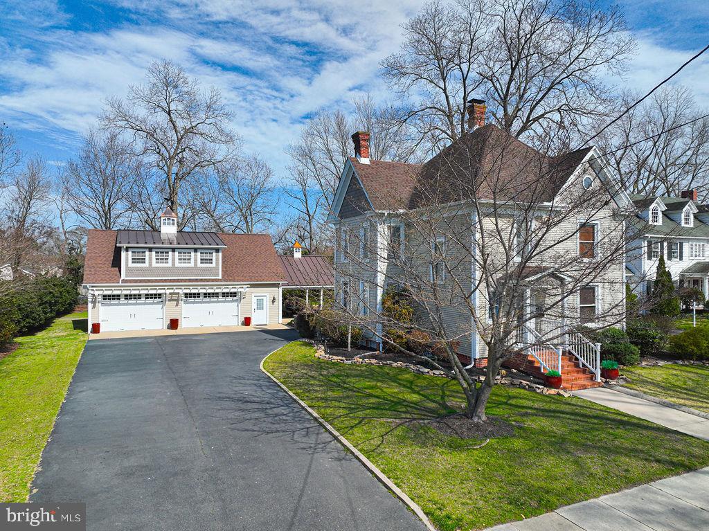 WOW!   If you are looking in the Pocomoke area, this is one of the finest homes offered for sale in quite awhile!    Look no further—this beautifully updated property has it all.  AND AT A NEW LOW PRICE!
Step inside to find a fully remodeled kitchen featuring granite countertops, tile backsplash, stainless steel appliances, and a convenient bar that opens to the dining area. The dining space is highlighted by a cozy gas fireplace, perfect for gatherings. Hardwood floors run throughout the kitchen and much of the main level, which also includes a comfortable family/TV room off the kitchen, a half bath, and an additional spacious living room.   Upstairs, you’ll find three bedrooms and two full bathrooms, all with beautiful hardwood flooring. During the colder months, you’ll appreciate the heated floors in the primary bathroom. The attic offers walk-up access and full flooring, providing excellent storage or future possibilities.   
If entertaining is your passion, this property truly shines outdoors. The highlight is a 30’ x 40’ Amish-built custom garage with a second floor offering 1,900 square feet of finished space, complete with HVAC and gas heat—ideal for recreation, hobbies, or additional gathering space.
Connected to the garage is a 16’ x 24’ pavilion with bar seating and a fully equipped outdoor kitchen featuring granite countertops, a built-in Blaze commercial stainless-steel grill with dual side burners, and a Big Green Egg smoker.    Located in a charming small town in Worcester County, you’ll enjoy the perfect balance of coastal access and community living. The home is just 30 minutes from Ocean City, MD, 30 minutes from Chincoteague, VA, and only a few blocks from the scenic Pocomoke River. Even better, kids can walk to award-winning public schools, the MarVa Theater, and the Delmarva Discovery Center.   The upper-level patio provides 500 square feet of space, and just off the pavilion is an additional 450-square-foot patio with a custom gas fire pit. With LED lighting throughout and 1,334 total square feet of outdoor entertaining space, the possibilities for hosting friends and family are endless.
Additional recent upgrades include a complete crawlspace encapsulation with dehumidifier, alarm system, and a water treatment system.    Upstairs HVAC replaced with dual fuel heat pump.  Gutter guards installed on home and garage.    New roof on shed.
Homes like this rarely come available--schedule your showing today before it’s gone.