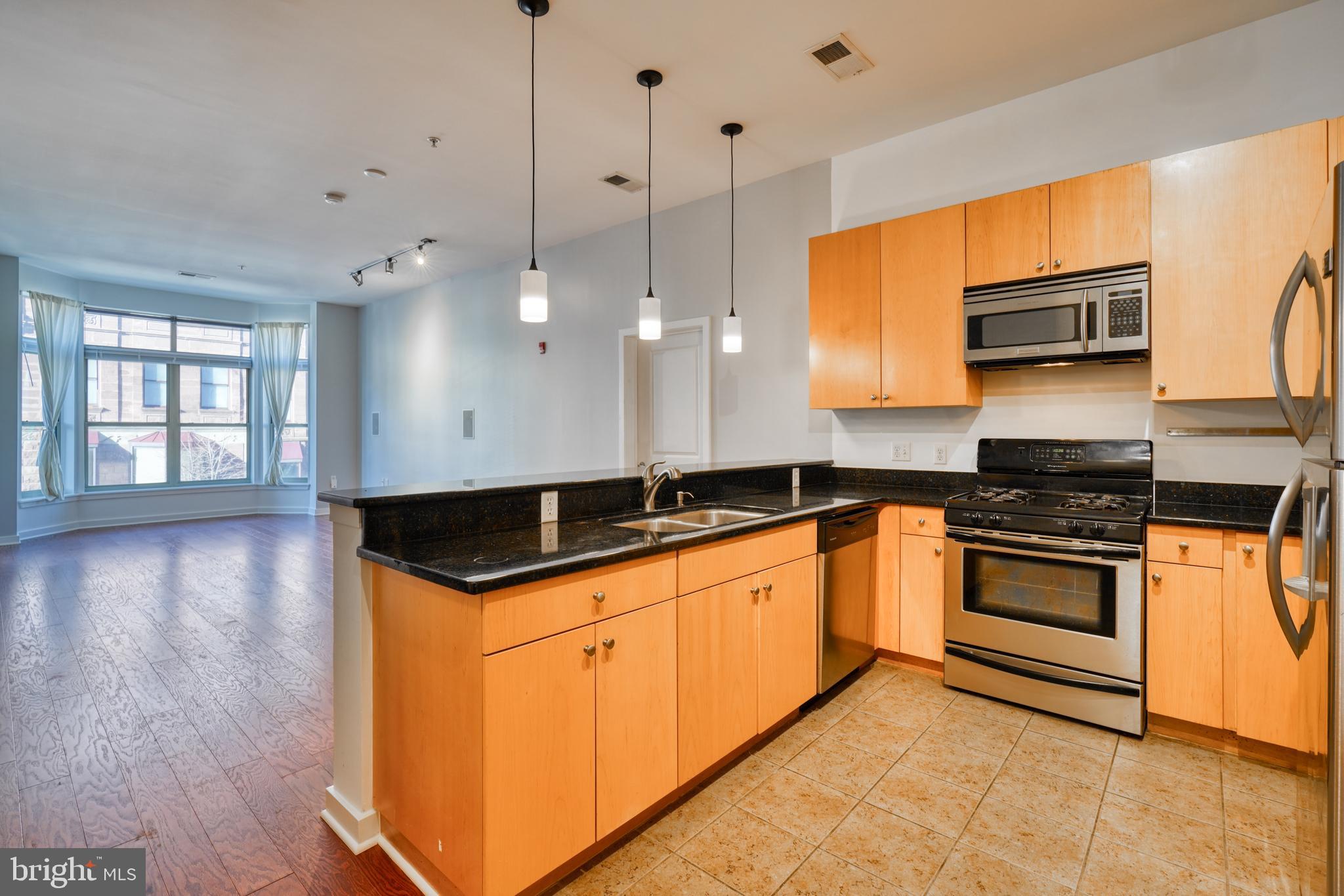 Situated above Starbucks, Chipotle, and Subway, this contemporary city condo offers prime living just a 5-minute walk away from Penn Station, the University of Maryland's Midtown Campus, and the Baltimore Symphony Orchestra. Conveniently close to I-83, The Belvedere, and popular local dining spots like The Owl Bar and Brewer's Art, this second-floor unit boasts secure entry, garage parking, and a well-thought-out layout with strategically placed bedrooms. Featuring 10-foot ceilings, hardwood floors, and nearly floor-to-ceiling windows, the condo includes gas heating, cooking, parking, and shared amenities like a gym and private courtyard. It's a must-see for those seeking a blend of convenience and comfort in urban living!