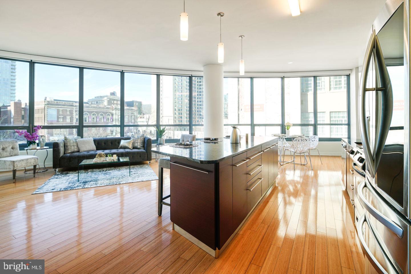 A spacious and luxurious "CURVED" condominium with amazing South and West facing views. This 2-bedroom, 2-bath residence features modern and luxurious finishes including granite countertops, wood floors, stainless steel appliances, 11-foot ceilings with floor to ceiling windows. The price includes a reserved parking space in the attached covered garage, and a storage locker. The building features a 24HR Concierge, fitness center, a heated 60FT lap pool, renovated sundeck/community room and much, much more! The building is situated conveniently next door to Trader Joes and Wine & Spirits - and is just walking distance from Philadelphia's top-rated restaurants. Spend the day shopping in Rittenhouse, or enjoying the sights at Boathouse Row, you can't beat the location and attractions located right near the Murano! Don't miss out on this unit. BOTH BEDROOMS HAVE BRAND NEW CARPETS INSTALLED