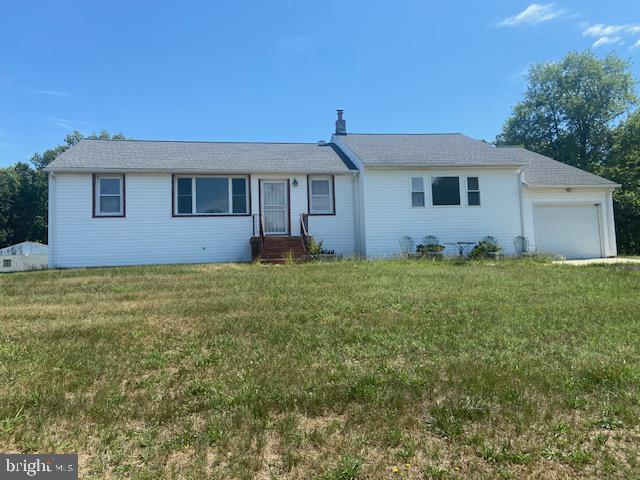 Detached rambler with one car garage, located on a 2.98 acre lot, shows well from the street