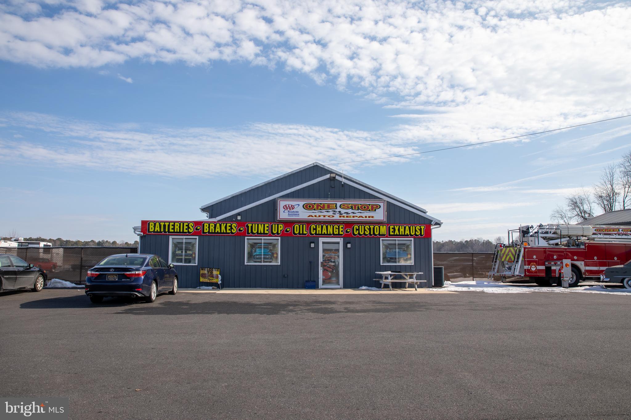 Commercial property consisting of two parcels at 2080 & 2098 Bay Road, Milford, offering multiple shop and storage buildings ideal for contractors, trades, automotive, marine, or light industrial use. The main 70’ x 40’ shop features an office four 12’ x 10’ overhead doors, providing excellent access for equipment, vehicles,  operations and additional office on side of shop. Additional improvements include a 30’ x 60’ building with  24’ x 12’ overhead door, and two sheds measuring 20’ x 8’ and 20’ x 14’. Functional layout with ample parking and high visibility along Bay Road. Property offers flexibility for owner-users or investors seeking well-equipped commercial space in Milford. Property has fenced in yard.
