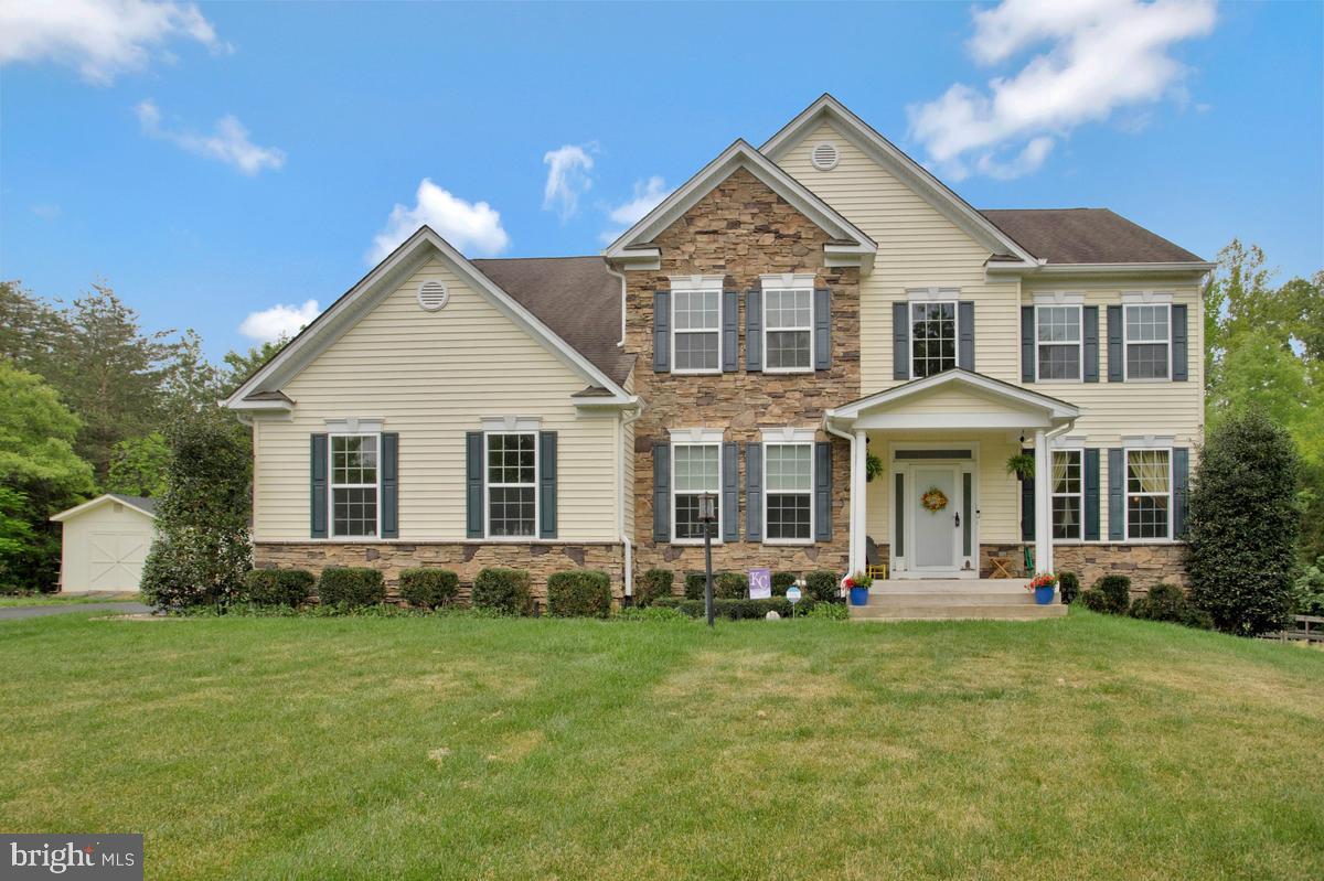 Nestled on a private 4.3-acre wooded lot, this beautifully updated 4-bedroom, 3.5-bath home with 4,748 sq ft of finished living space offers the perfect blend of space, comfort, and tranquility! An open floor plan with crown molding in the formal living and dining rooms and a stunning cathedral ceiling in the primary suite set the tone throughout. The kitchen is equipped with newer appliances, including a refrigerator (2018), dishwasher (2020), and microwave (2020), while major systems have been updated including a new HVAC compressor in 2026. The inviting living area showcases a remodeled fireplace with a custom stone accent wall (2023). Step outside to enjoy a large wooden deck and two newly added cement patios (2024), perfect for entertaining or relaxing while taking in the peaceful, wooded surroundings filled with wildlife. Located in a quiet, family-friendly neighborhood with access to a 150-acre wooded area for hiking and outdoor activities, and just minutes to shopping, dining, commuter routes, and I-95.