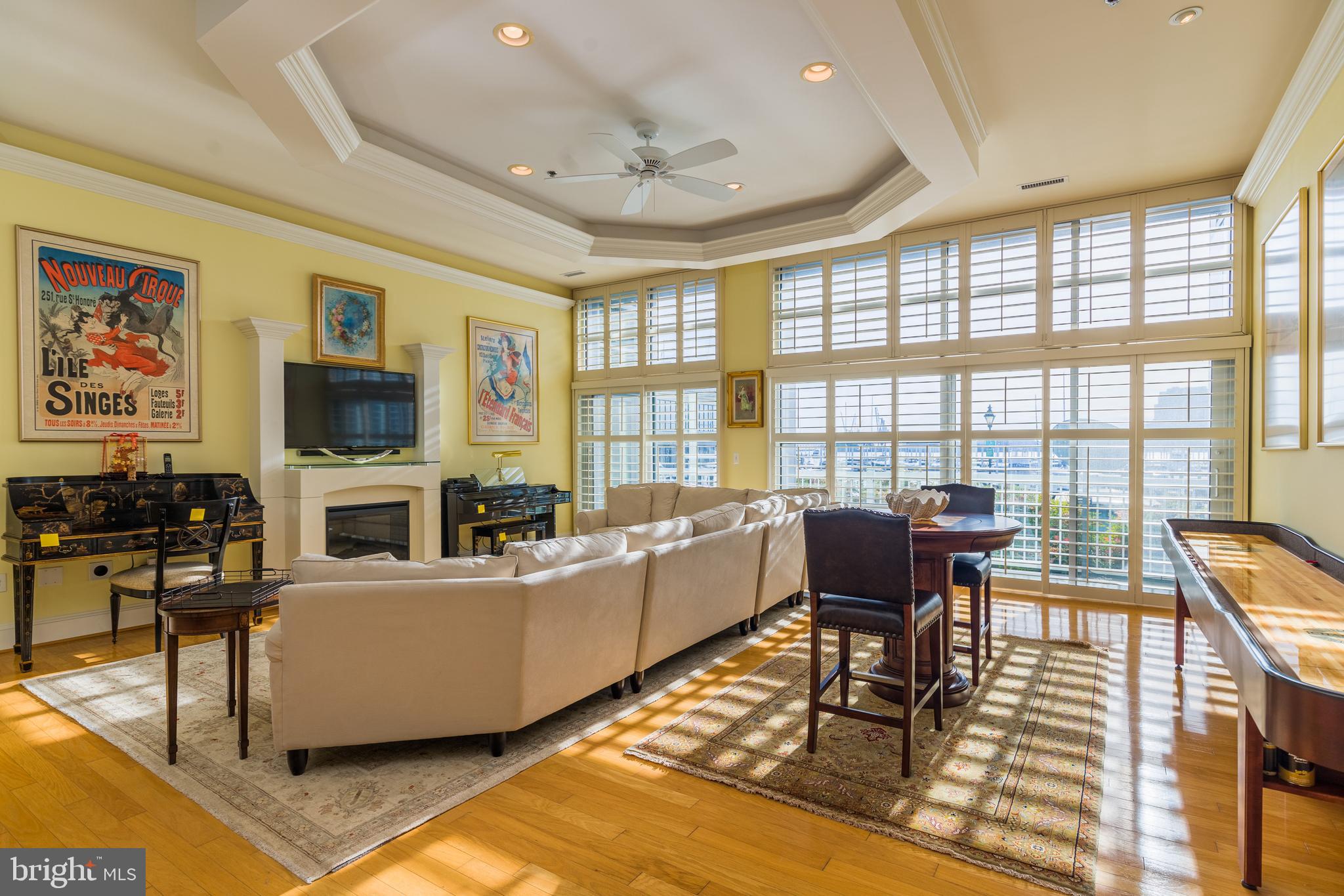PRICE IMPROVEMENT!  LUXURY RESORT LIVING AT IT'S FINEST!  Absolutely stunning  unit   with WATER VIEWS.  Eleven foot  ceilings.   Gleaming hardwoods.  Floor to ceiling windows with custom blinds.   Crown molding throughout.  Coffered ceiling.   State of the art kitchen with oversized island.   The primary bedroom  has a dressing area and dual custom closets.    The balcony looks directly over the Inner Harbor and has dual access.  No detail was missed in this pristine unit  Located in one of Canton's premier buildings. Gated entrance.   Two assigned parking spots. Just seconds from the promenade SELLER IS MOTIVATED!