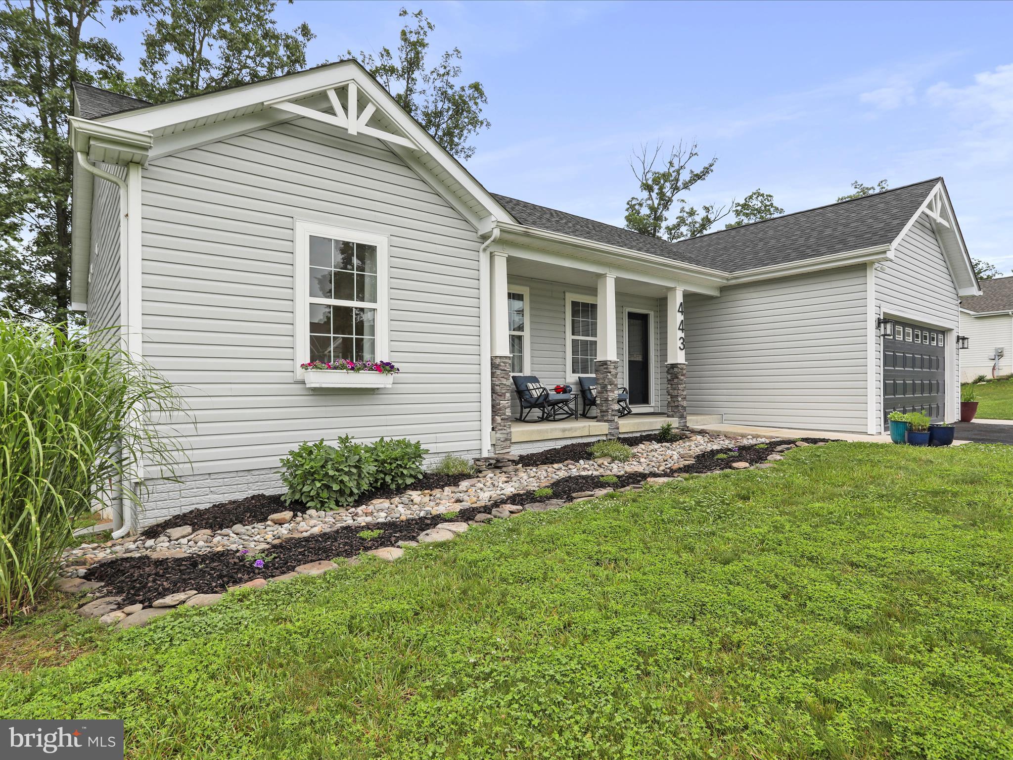 Open House this Saturday from 12-2! Get the benefits of ‘like new’ without the wait—this home is ready today! Do not miss out on this one! It is a must see! Forget construction delays—this stunning home is ready for you now! Nestled in a serene community, this stunning ranch-style home, built in 2019, offers a perfect blend of modern comfort and timeless charm. With 4 spacious bedrooms and 3 full bathrooms, this residence is designed to meet the needs of today's homeowner. Step inside to discover an inviting interior that boasts an abundance of natural light and thoughtful design. This home is like new and has been meticulously maintained, showcasing pride of ownership in every detail. The open layout seamlessly connects the kitchen with island and granite countertops, to the dining area, making entertaining a breeze. Cozy up in the living room by the gas fireplace, complete with elegant mantel, perfect for those chilly evenings. The main level includes three convenient entry-level bedrooms, ideal for guests or as a private office space. Each bedroom is generously sized, with the primary suite featuring a luxurious soaking tub in the attached bathroom, providing a personal retreat for relaxation. Additional interior highlights include recessed lighting, ceiling fans, and custom touches throughout creating a warm and inviting atmosphere. The basement expands your living space, offering a versatile area for recreation, hobbies, or additional storage and an additional bedroom. Equipped with a generator hookup, this home offers peace of mind and added convenience during power outages—ensuring comfort and security no matter the weather. Outside, the property is equally impressive. Set on a spacious 0.87-acre lot, the home backs to tranquil trees, providing a peaceful backdrop for outdoor living. Enjoy the extensive hardscape, perfect for summer barbecues, or relax on the deck and stamped patio while the kids play on the included swings. The beautifully landscaped front yard and sidewalks enhance the curb appeal, making this home a true standout in the neighborhood. Parking is a breeze with a front-entry attached garage and a paved driveway, accommodating multiple vehicles. This home is not just a place to live; it's a place to create lasting memories. Experience the perfect blend of comfort, style, and functionality in this exceptional property. Don't miss the opportunity to make it your own!