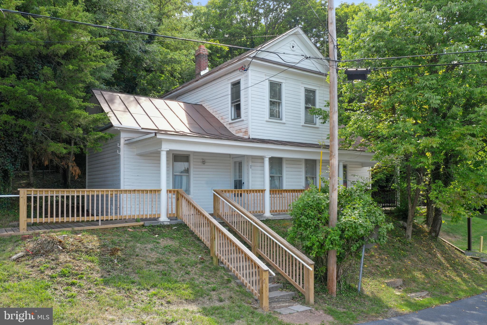 Experience the timeless charm of this classic Cape Cod-style home, originally constructed in 1900 and thoughtfully expanded with a modern addition in 1980. Perfectly situated on a 0.352-acre corner lot in the heart of Romney, West Virginia, this home seamlessly blends historic character with contemporary comfort. Boasting over 1,800 square feet of living space, this solidly built home features five generously sized bedrooms and two full baths, offering flexibility for families of all sizes. The updated kitchen merges modern convenience with the home’s enduring charm, making it a welcoming space for both casual meals and formal gatherings. Beneath the home lies a massive unfinished basement, providing endless possibilities for future expansion—whether you envision a recreation room, home gym, or additional living quarters. There’s no shortage of storage, ensuring a clutter-free living environment. Step outside to discover a beautiful, expansive yard—perfect for relaxation, entertaining, or even future development. The property also includes a two-car carport and a cozy front porch, where you can unwind while enjoying scenic views of the town and surrounding mountains. Whether you’re looking for a charming residence or an investment opportunity, this property has immense appeal. Its spacious layout and idyllic location make it a prime candidate for short-term rentals, offering potential for additional income as a vacation home or investment property. Nestled in a small-town setting with convenient access to local amenities and outdoor recreation, this home is ideally positioned for commuters—just 45 minutes from Winchester, Virginia, and two hours from Washington, D.C. Enjoy the best of both worlds: peaceful, small-town living with easy access to bustling city life. This Cape Cod-style gem offers a harmonious blend of historic elegance and modern functionality, making it a standout choice for any buyer.