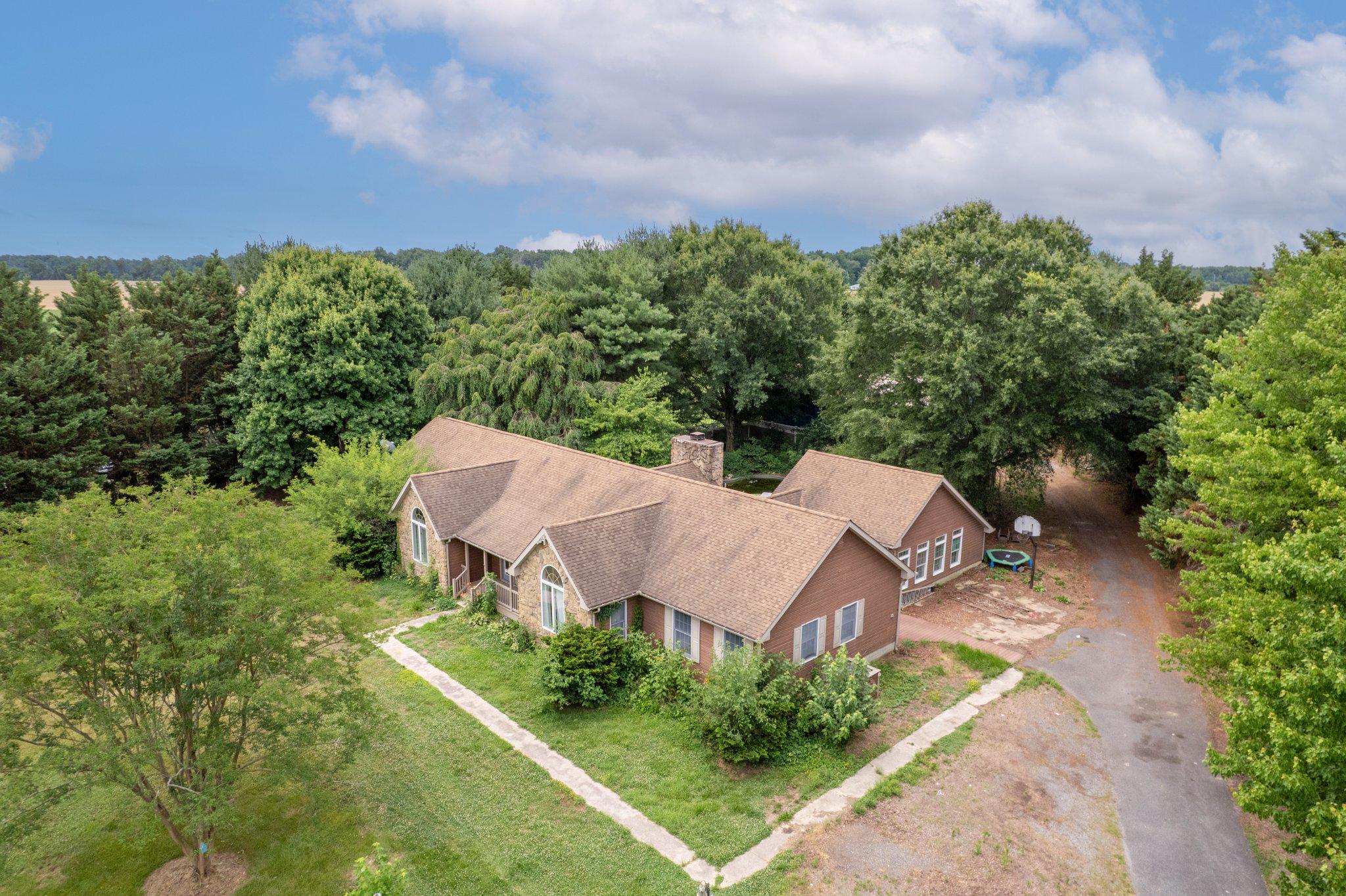 Enjoy the opportunity to create your own Eastern Shore retreat on 2 private acres surrounded by picturesque farmland. Conveniently located just a short drive from St. Michaels, Kent Island, and the Queenstown Premium Outlets, this spacious contemporary ranch home offers over 3,300 square feet of living space and exceptional potential.
Priced accordingly, the property is being sold AS-IS and will benefit from repairs, updates, and cosmetic improvements, presenting an excellent opportunity for investors, renovators, or buyers looking to personalize a home to their tastes. With its desirable Eastern Shore location, substantial square footage, acreage and versatile outbuildings, this property offers the chance to create something truly special.  
The home features a flexible floor plan with a floor to ceiling stone fireplace in the family room,  cathedral ceilings in family room, kitchen and primary bedroom, separate dining room, and eat-in kitchen with island.  The previous owners' 2007 addition included 2 additional bedrooms and a full bath taking this home to a 5 Bedroom - 3.5 bath home and also converted the attached garage into a Rec Room all permitted with QA's County (see MLS docs).
Outside, the property offers a variety of amenities ready for your TLC, including an in-ground pool (opened 2025 season pool pump is not operational), deck, a 30’ x 50’ pole barn built in 2020, and storage shed. The expansive grounds provide plenty of room for gardening, recreation, hobbies, or simply enjoying the peaceful rural setting and open views of the surrounding countryside.
Bring your vision and discover the possibilities this unique country property has to offer.