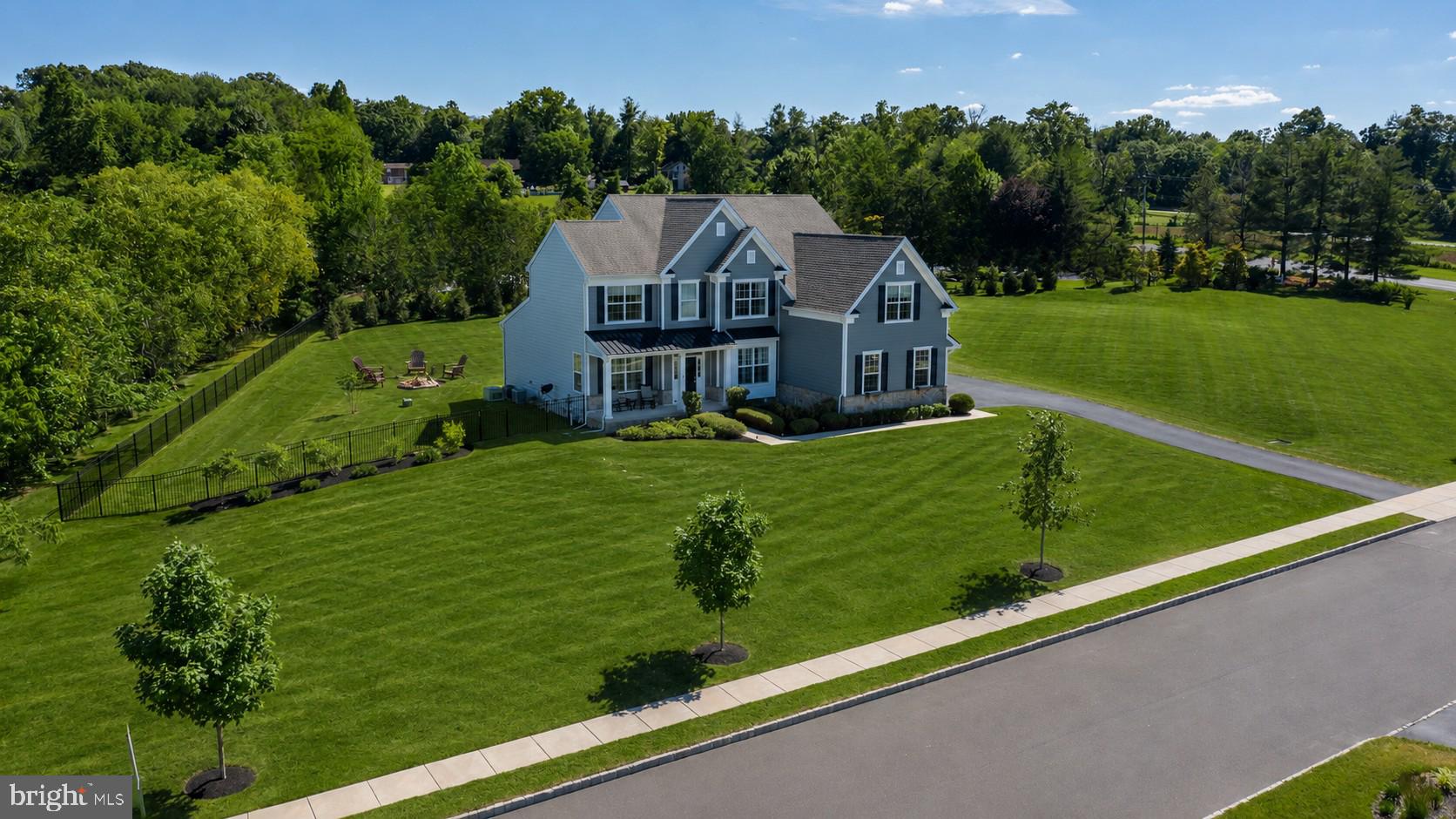 Some homes simply check the boxes. Others make you imagine the life you could build there. Welcome to Anderson Preserve, one of Newtown's best-kept secrets, where luxury, privacy, and everyday comfort come together on 1.64 breathtaking acres within the award-winning Council Rock School District. Beautifully maintained grounds, an expansive front lawn, generous side yard with room to envision a future pool, and a private backyard retreat create the perfect backdrop for entertaining, relaxing, and making lasting memories. Picture evenings around the fire pit, unwinding on the composite deck, and enjoying time with family and friends beneath the open sky. From the inviting covered front porch to the light-filled interior, this home was thoughtfully designed for the way you live. The gourmet kitchen features custom cabinetry, granite countertops, an oversized island, top-of-the-line appliances, and a walk-in pantry, flowing effortlessly into the spacious living room with a propane fireplace. Plantation shutters enhance the formal dining room and dedicated home office, while a first-floor bedroom with an adjoining full bath offers exceptional flexibility for guests, multi-generational living, or a private main-level retreat.
A custom mudroom with built-in storage, beverage station, and access to the three-car garage with professionally finished epoxy flooring keeps everyday life beautifully organized. Upstairs, the primary suite offers a spacious sitting area and a spa-inspired bath featuring custom shiplap detailing, upgraded tile, and a frameless glass shower. Three additional bedrooms, beautifully appointed baths, and a custom laundry room complete the second level. The finished walk-up lower level lives like an extension of the home, offering a full bath, kitchenette, second laundry room, exterior access, and a dedicated recording booth—an unexpected feature that truly sets this property apart. Whether hosting guests, creating a private retreat, or designing the ultimate recreation space, the possibilities are endless. Meticulously maintained with hardwood flooring throughout the upper-level bedrooms, fresh neutral paint, and quality finishes, this exceptional home blends timeless craftsmanship with modern functionality. Just minutes from historic Newtown Borough, shopping, dining, and major commuter routes, this is more than a beautiful home—it's where your next chapter begins. Estimated finished living area, including the lower level: approximately 4,612 sq. ft. Public records may not accurately reflect lot size or square footage. Buyers are responsible for independently verifying all dimensions and property information.