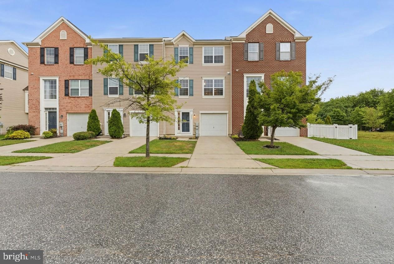 Welcome to this beautifully maintained three-level townhome offering 3 bedrooms, 2 full bathrooms, 2 half bathrooms, and a one-car garage. The entry level features a versatile flex space that's perfect for a family room, home office, playroom, or home gym, along with a convenient half bath and interior access to the garage.

The main living level boasts an open-concept design that's perfect for both everyday living and entertaining. The spacious kitchen is the heart of the home, featuring a large center island with seating, abundant cabinetry, generous counter space, hardwood flooring, and plenty of natural light. The kitchen flows seamlessly into the dining area and living room, creating an inviting space for gathering with family and friends. An additional half bath completes this level.

Upstairs, you'll find a spacious primary suite complete with a walk-in closet and private en-suite bathroom, along with two additional bedrooms and a full hall bathroom.

Ideally situated just minutes from I-695, I-95, shopping, dining, and everyday conveniences, residents also enjoy access to community walking trails, lakes, a beach area, and the popular Hard Yacht Café. Combining space, functionality, and an unbeatable location, this move-in ready home is ready for its next owner.