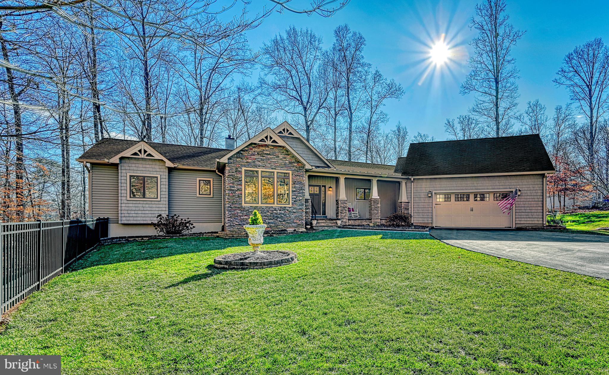 This beautiful custom home on the Private side of Lake Anna was lovingly designed with entertaining and lake-life enjoyment built into every detail. You will delight in entertaining family and guests in this well-accommodated home. The oversized gourmet kitchen and dining combo flow effortlessly to the living area and out to the deck, where the Sunsetter Shade will keep you cool. At the same time, you can prepare your favorites using the deck grill, which has a gas line hooked up to your household buried propane tank. The Chef will savor every minute in the kitchen with its multitude of amenities and granite countertops. There will be no shortage of baking options with the built-in GE Profile wall oven with an Advantium convection microwave, PLUS a five-burner glass top range with two more ovens! The Sous Chef will appreciate the prep sink on the island and the cabinet that houses a pop-up mixer stand! Cabinetry abounds in the kitchen, and just steps away, in the dream laundry room, are spacious pantry cabinets with pull-out shelves. Clean-up will be a breeze with the double kitchen sinks and dishwasher. Be sure to check out the "dust sweep" under the island that whisks the dirt into the whole house vacuum.  Looking for a quiet place to relax? The lakeside sunroom will soothe you while you read or nap. This would be an amazing overflow sleeping space and/or office. Climb the stairs to the bonus room over the attached two-car garage, and imagine how many bunk beds you could place here. The room includes a built-in sink, so the possibilities for this room are endless.  The spacious living room offers lake views and boasts an amazing 35,000 BTU German Bari Soapstone wood stove that will entice you to spend cozy winter nights at the lake. The main level master suite takes advantage of the peaceful lake views and offers a generous master bathroom and clever closet with barn door entry. The renovated lower level continues to add delight with a fun family room that includes a built-in sink, wine cooler, entertainment center, and built-in window benches. Step outside and enjoy the privacy of the stone patio with an inviting fire table.  Guests will rest well in one of the three lower-level bedrooms (1NTC) and flip a coin to see who scores the generous master bedroom suite with an elegant bathroom, double sinks, a stunning shower, and an oversized closet. But the fun doesn't end there! The hobbyist will drool when they see the large lower-level workshop, perfect for all sorts of projects. Foundation is Superior Walls.
But don't forget fun at the waterfront! A lighted paver walkway will lead you to approximately 150 feet of shoreline at the mouth of a small cove. The double boat house has two lifts, a sun deck, and a convenient storage room. The cove location is out of the heavy boat traffic area and perfect for relaxing floats in the lake. The owners just recently added a lovely paver patio and fire pit with a wood stacking station at the waterfront.  Don't miss the 12x20 tool shed!
The owners have exceeded minimum standards ensuring quality for comfort, convenience, and energy efficiency.  The attic has double the required insulation. Two Rennai Tankless Hot Water Heaters ensure hot water is delivered to both ends of the home. A two-stage water filtration system and two radon remediation systems to be doubly sure your water and air are good. The owners replaced the original gutters with larger 6" gutters and added gutter guards. These conscientious sellers have just had a pre-listing home inspection done and will fix the few minor items found to make sure it's ready for the buyers to enjoy right away. The septic was pumped in April, the HVAC was upgraded in April and maintained in August - the remainder of the one-year maintenance agreement will convey to the buyers.  
Any time of day, any season of the year, this lovingly cared-for home will be central to your enjoyment of Lake Anna.