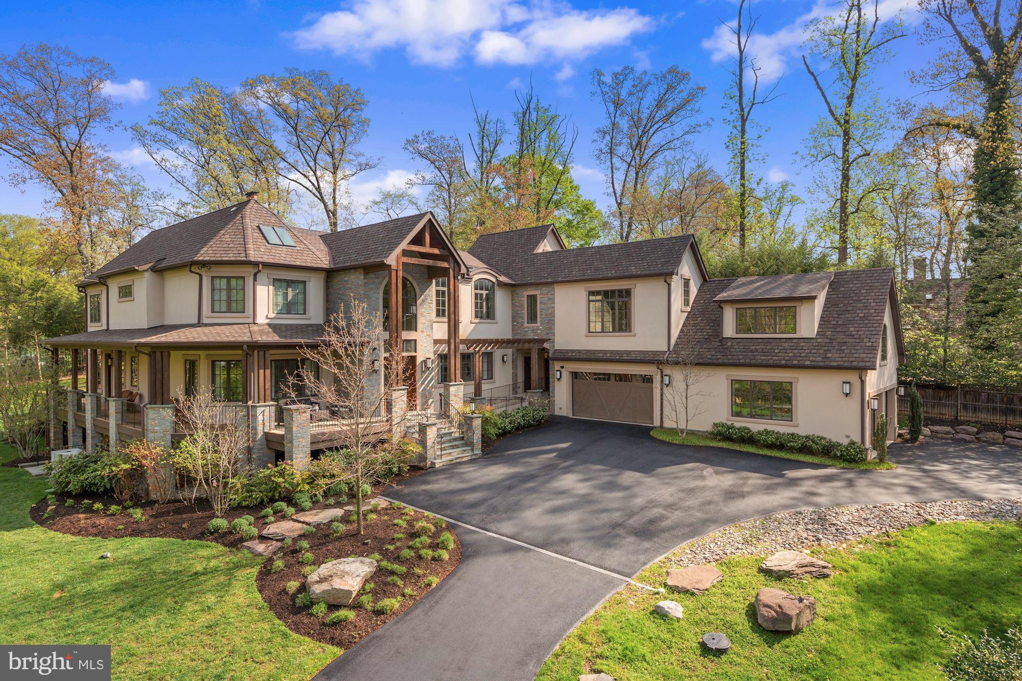Sublime luxury living is in store for you in this elegant contemporary home located near Potomac Village.  The gated entry and circular driveway provide an approach to the impressive stucco , stone and beam home and its private 1.35-acre grounds. Built in 2014 and looking new, the home offers a resort environment with 11,500 square feet of serene, light-filled space and countless luxury features, wonderful indoor/outdoor entertaining, quiet enjoyment of nature, multi-generational living and professional at-home work with multiple work spaces.  The Foyer reveals the home's open flow, large interior spaces, lovely spiral staircase and sparkling Living Room. At the heart of the home, the Great Room with soaring two-story ceiling offers a large sitting area focused on the stone fireplace, a butlers bar, and opens to the covered patio and breathtaking Gourmet Kitchen. The wonderfully sleek Kitchen offers dual center islands, highest quality stainless appliances, three sinks, two dishwashers, and walk-in pantry. The adjoining Breakfast Room provides views of the extensive outdoor entertaining space and grounds.  There is a lovely Dining Room, Office and additional Sitting Room or Den, all with the home's signature large windows. A spacious Owner's Bedroom Suite with gorgeous Full Bath sits on the Main Level. A large Mudroom with Laundry and built-ins provides access to the garages. An Elevator is among the features making this a handi-cap accessible home. Upstairs, via the main or second staircase, the Second Owner's Suite offers luxurious space including a sitting area and two balconies offering views of the lawn and trees, as well as two large walk-in closets and a sumptuous Full Bath. The Upper Level provides an open overlook to the Great Room below, as well as a large Family Room or Entertainment area. This level offers three additional Bedrooms, each with its own Bath. Two of the Bedrooms share an entertainment loft above. A large professional Office on the Upper Level sits above the garage, and has its own separate outside entry and Bathroom. The daylight fully finished Lower Level offers walk-up stairs to the lawn, a large Recreation Room, Media Room, Full Bar, Spa Room with sauna, Gym and additional space.  Wonderful exterior finished space includes a stone fireplace with waterfall feature, hot tub, built-in grill and covered bar and entertainment area. Two garages are configured to provide 4 spaces, with a 22-foot ceiling and basketball hoop and electric car charger.    A pool can be easily added in two possible locations and renderings are available.  Features include geo-thermal HVAC with 5 zones, insulated concrete form construction, Energy Star rating, Smart Home controls, zoned sound system, gorgeous hardwood flooring, skylights, radiant floors, oversized triple pane windows. Monthly heating and cooling costs average less than $450 including Tesla charging. Geothermal and air circulation systems continuously pump in fresh air and remove stale air and pollen - a gift in the Covid environment. The custom property was thoughtfully constructed to the highest standards and provides an unusual opportunity for today's buyer.