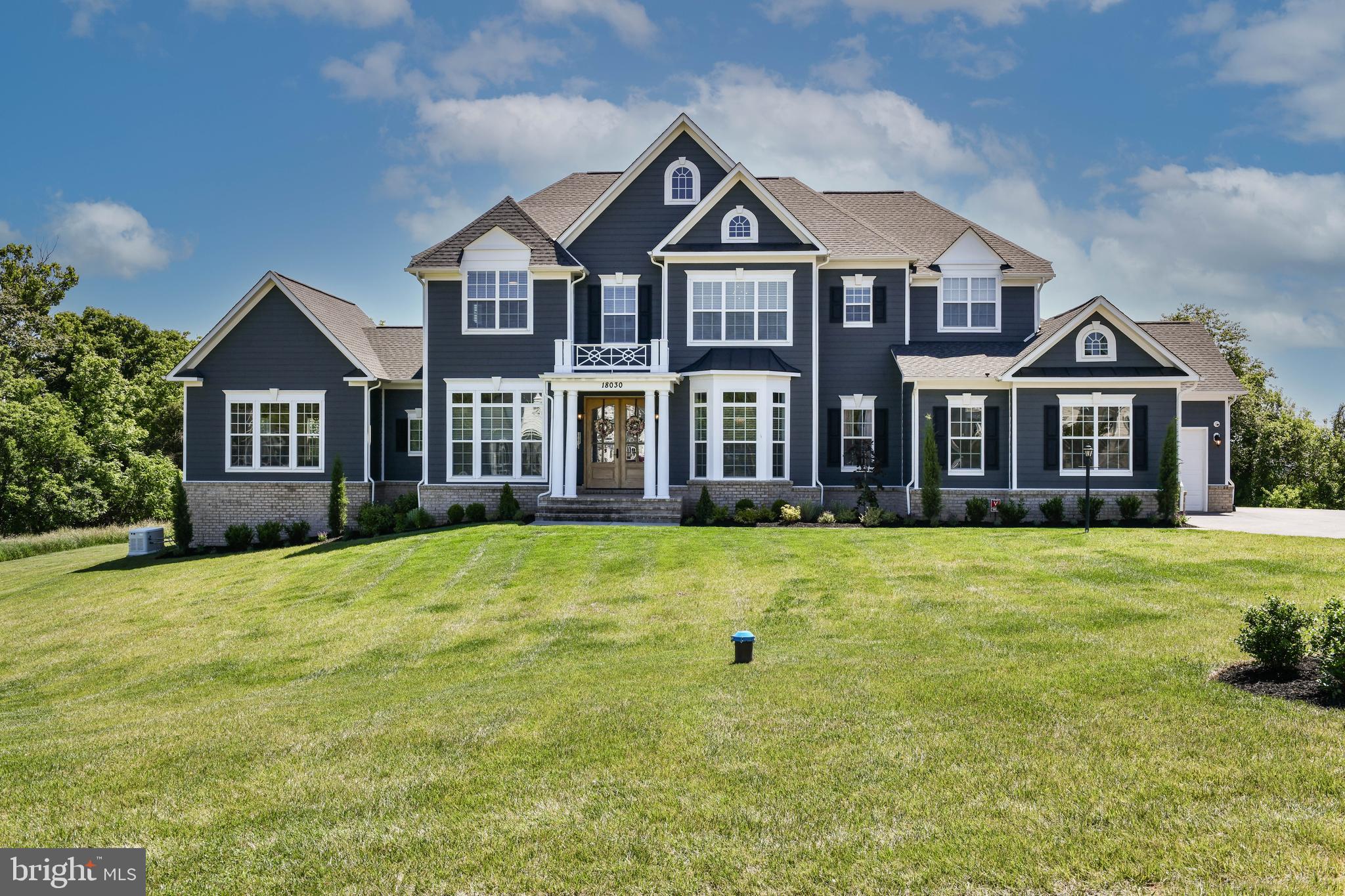 Rare opportunity — one of the final Carrington Homes communities in Loudoun County.
Price Improved — $2,555,000
Set on a private 1.5-acre homesite with sweeping sunrise views, this nearly 7,000-square-foot Glen Springs Grand offers 6 bedrooms, 6.5 baths, and custom-level craftsmanship across three fully finished levels — now priced well below original new-construction cost, with zero build wait.
Just minutes from historic downtown Leesburg and the W&OD Trail, this home puts you close to everything that makes Western Loudoun living so sought after — King Street dining and shopping, weekend farmers markets, scenic trail access for biking and running, and an easy commute to Washington, DC and surrounding areas. 
Curb appeal that stands apart: beautifully landscaped, double mahogany front doors with sidelights and transom, oversized molded brick watertable with flagstone steps, HardiePlank siding on all four sides, standing seam Pac-Clad accents, and a 3-car side-load garage.
Inside: 10-foot main-level ceilings, a grand oak staircase, beamed kitchen ceiling, coffered ceiling in the extended family room, and 2¼" hardwood floors throughout the main level.
Kitchen: GE Profile stainless suite with 5-burner gas cooktop, double wall oven, and built-in fridge; Timberlake 42" full-overlay cabinetry; granite counters; oversized island; butler's pantry — opening to the family room and a Trex deck with those sunrise views.
Layout: Main-level guest suite with full bath for multigenerational flexibility. Upstairs owner's suite with vaulted ceiling, dual walk-in closets, frameless glass shower with dual shower heads, and a freestanding soaking tub.
Lower level: Fully finished walkout basement with custom bar, game room, rec room, media room, and den — flooded with natural light.
As Carrington shifts its focus to Winchester, Main Tree Farm is one of the last small communities the builder is completing in Loudoun County — a rare opportunity to own a true Carrington community home at a meaningfully improved price.