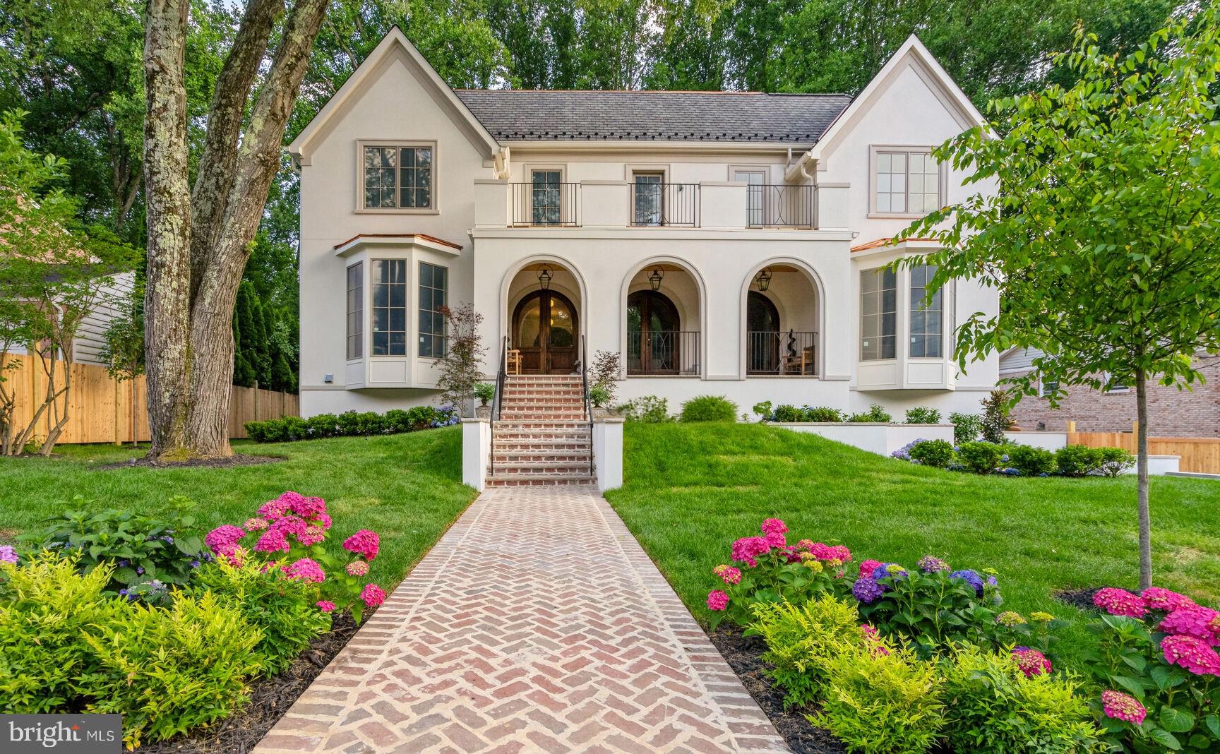 Nestled in prestigious McLean, Virginia, one of the DMV’s most sought-after neighborhoods, this home blends suburban tranquility with urban convenience. This custom residence offers luxury, functionality, and exquisite craftsmanship in a premier location.
 
Upon entering through the arched porch and Mahogany doors, the grand foyer with Solid White Oak Versailles parquet sets the tone for the home's special character. The living room features a Louis XV Carved Marble fireplace mantel with a gas insert, and the family room boasts a hand-restored antique Empire wood mantel. The dining room is adorned with a custom wallpaper mural, and the main floor library/office includes wall-to-wall built-ins.
 
The gourmet kitchen features custom painted maple and stained red oak cabinets, soapstone and marble countertops, and top-of-the-line appliances, including Subzero, Wolf, and Bosch appliances. The back kitchen and butler’s pantry include additional appliances and specialized sinks. Lighting fixtures blend modern and antique styles, including Louis XV Rococo bronze sconces and various high-end brands throughout. Off the family room, discover a private backyard brick patio garden, with covered and uncovered spaces, a neatly manicured landscape and privacy fencing.
 
Upstairs, the Owner’s suite has coffered ceilings, a Brazilian teak terrace with backyard views, and a luxurious bath with a freestanding tub, double vanity, marble tiles, and spacious walk-in closets. Three additional bedrooms with ensuite baths and an upper-level laundry complete the 2nd level, while the 3rd level features a loft, bar, 5th bedroom, and full bath.
 
The lower level includes polished concrete flooring, recreation spaces, an insulated wine cellar, a bar, and a fireplace. Find the 6th and 7th bedrooms, one with an ensuite bath, offering guest and au-pair accommodations. The lower level also has separate access to the 2-car garage, making all points DMV just moments away.
 
Additional features include Pella windows, custom vanities in all baths, and marble and porcelain tile floors in select areas. The home includes two laundry zones, a herringbone pattern for walkways and patios, an elegant stucco exterior, and Bevolo Gas Lanterns lighting the entry. Smart Home features include a Sonos system, Ring doorbell, Nest thermostats, tankless water heaters, Wi-Fi repeaters, and direct Ethernet connections. The home has four zones of heating and cooling for efficient climate control and was engineered to allow for a 4-floor elevator (optional).

Video link: https://youtu.be/YB4Rhwex7kQ?si=kHeIuEp0FllWkiSE
