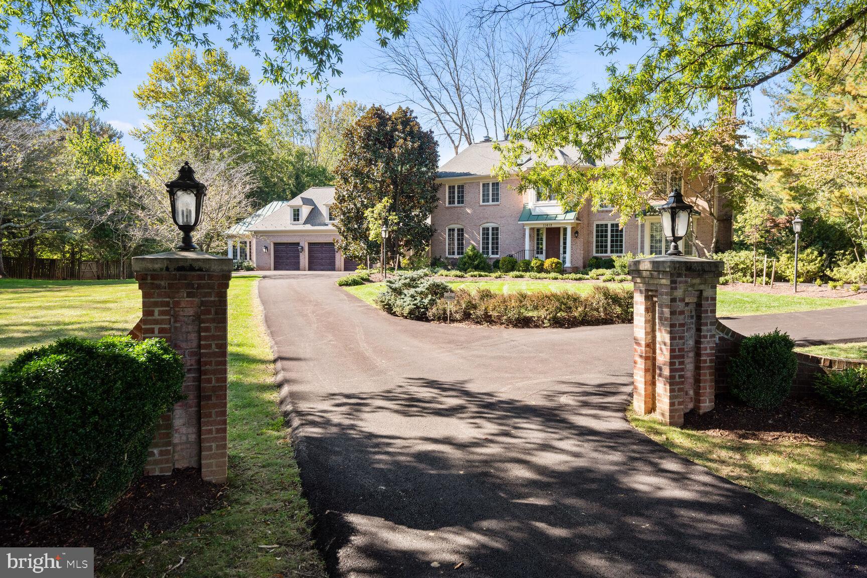 Welcome to this sensational expanded/updated colonial with over 5,750 sq ft of living space throughout 3 levels, sited on an idyllic 2-acre lot with a circular drive, a 3-car garage, and a tranquil private backyard designed for entertaining & relaxation with multiple decks & terraces, and a heated inground pool!  The main level of the home has a welcoming foyer entry with a coat closet, powder room, a 5th bedroom w/ensuite full bath (currently configured as an office/library but easily converted into a bedroom), with rich built-in cabinetry & shelving, and built-in bar, the formal living room with a fireplace & bay window, formal dining room with bay window, an updated and open kitchen w/premium cabinetry, granite tops & a breakfast room with a bay window.  The oversized family room showcases a fireplace with a raised hearth, custom built-ins, and a wall of windows & French doors that open to the pergola-covered deck and terraces.  The hallway accesses the large walk-in pantry closet and an exit door to the breezeway/screened-in porch and entrance to the oversized 3-car garage (with a "dog bath" and stairs to a floored attic for extra storage), AND a 10'x17' greenhouse with cabinets, countertop with sink, high ceiling, and separate A/C system.  The upper level encompasses a luxurious primary bedroom suite with 2 walk-in closets, a cozy sitting/dressing room with fireplace & custom built-ins, and an updated spa bath with a dual sink vanity, separate tub, and a large glass enclosed shower.  There are 3 additional generously sized bedrooms (one with an ensuite full bath) and a 3rd full bath.  The lower level walkout has a huge recreation room (pool table conveys) with a fireplace, a built-in bar, a den, a full bath that opens to a sauna, and the laundry room.    Other amenities include hardwood floors throughout most of the main & upper levels, 9' ceiling height on the main level, a whole house backup generator & pool heater (fueled by propane gas),  architectural shingle roof (approx. 10 years), 2 HVAC systems (one system/2019) and an 80-gallon water heater (2015).  You'll feel like you're in the country, but this beautiful property is just minutes from Potomac Village!  Open Saturday (3/23) & Sunday (3/24) from 1-3 pm.