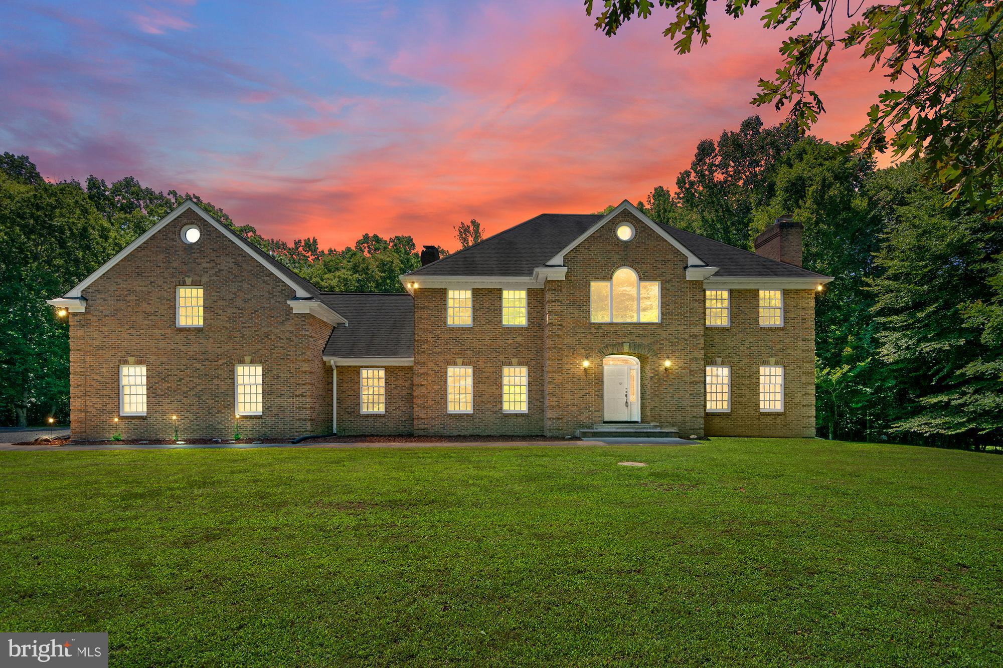 **Open House - Saturday, July 18th, 12 - 2 pm**
Welcome to this exceptional, custom built all brick, 5-bedroom, 4-bathroom home in the sought-after Edelen Estates community of Bryantown, offering over 4,000 square feet of beautifully designed living space on more than 3 private acres. Set back on a picturesque homesite with a 3-car garage, this impressive property offers the perfect blend of space, comfort, and functionality. Step inside the grand two-story foyer, where you're welcomed by an elegant living room featuring a stunning stone fireplace. The thoughtfully designed main level flows seamlessly into an additional living and dining area, creating the perfect setting for both everyday living and entertaining. A versatile main-level room offers endless possibilities as a home office, guest room, or potential main-level bedroom. The spacious kitchen is complete with abundant cabinetry, generous counter space, and a dedicated dining area, while the oversized laundry room with built-in cabinetry provides exceptional storage and convenience. Just beyond the kitchen, a warm and inviting family room with a cozy pellet stove creates the perfect place to gather. Upstairs, you'll find five generously sized bedrooms, including a luxurious owner's suite featuring a large sitting room (could easily be a 6th BR) an expansive walk-in closet and a spa-inspired ensuite bathroom with a dual vanity, jetted soaking tub, and separate walk-in shower. One secondary bedroom enjoys the privacy of its own ensuite bathroom, while the remaining bedrooms are served by a well-appointed hall bath, offering plenty of space for family and guests. The expansive unfinished basement with two fireplaces and 12 foot ceilings provides endless opportunities to create additional living space, a recreation room, home gym, workshop, or whatever best suits your needs. Enjoy incredible comfort and savings from the geothermal HVAC system and 2x6 construction too! Surrounded by the beauty and privacy of over 3 acres, yet conveniently located in the desirable Edelen Estates community, this remarkable property offers the peaceful lifestyle you've been searching for without sacrificing convenience. Don't miss the opportunity to make this exceptional home your own.