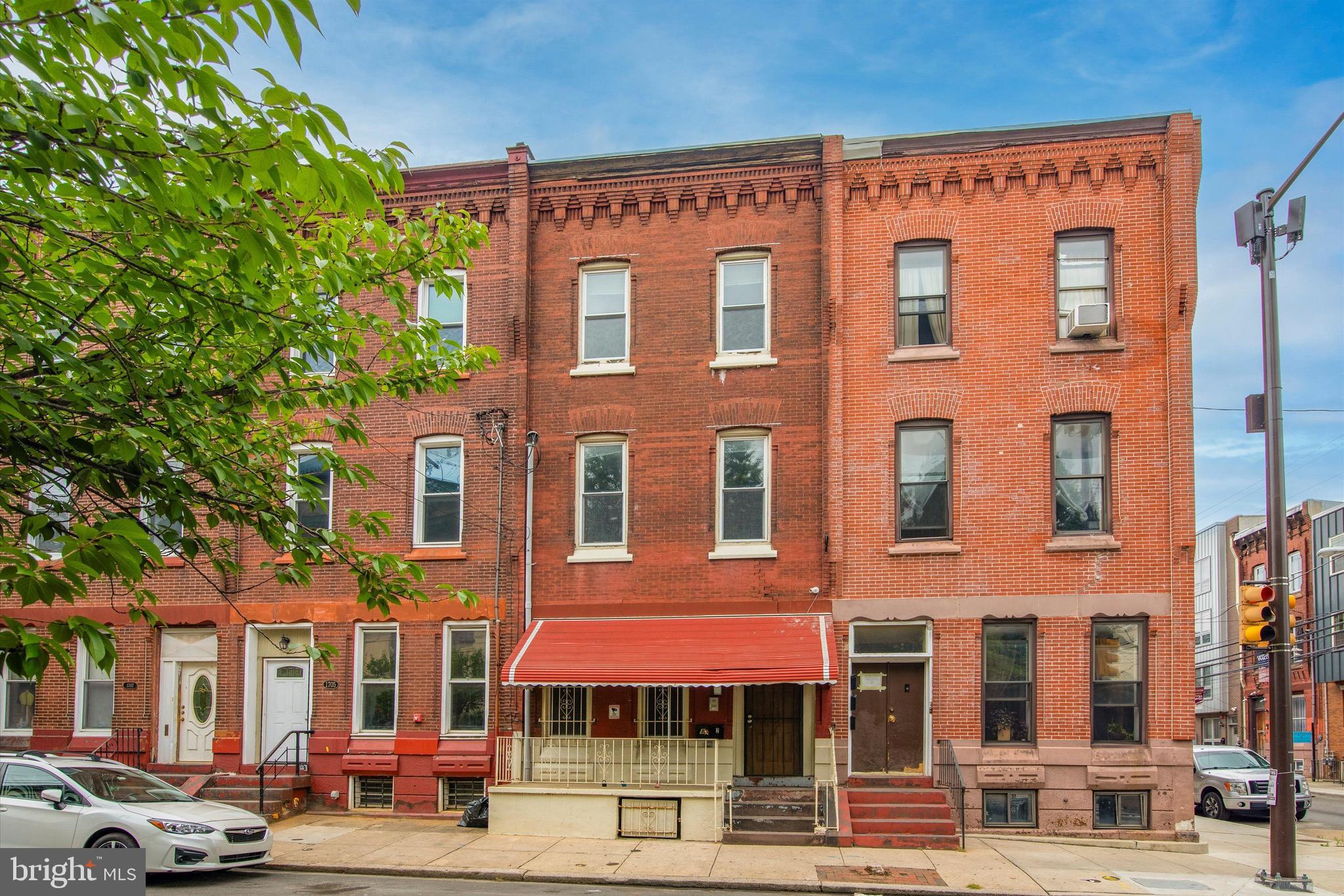 Welcome to 1703 W Montgomery Avenue, a turnkey duplex investment opportunity located just two blocks from Temple University and across the street from the Philadelphia Police Department. Fully leased through July 2027 with contracted rents of $6,060/month through 7/31/26 and $5,920/month through 7/31/27, this property offers strong in-place cash flow and consistent rental demand. The building consists of two bi-level units, each featuring 4 bedrooms and 2 full bathrooms with spacious layouts designed for student living. Recent upgrades and features include solid hardwood floors, granite kitchen islands, stainless steel appliances, in-unit laundry, Goodman high-efficiency HVAC systems, security cameras, hardwired Ethernet, intercom systems, and master-keyed locks with interchangeable cylinders for efficient management. Unit 1 includes a private rear yard and finished lower level with additional living space and a granite-top bar, while Unit 2 offers expansive living space with Center City skyline views. The property also benefits from a valuable group living use permit, permitting use as a single room residence (8 rooms) within the existing structure. This is a low-maintenance, professionally maintained investment opportunity with strong cash flow, modern systems, and a prime Temple-area location.