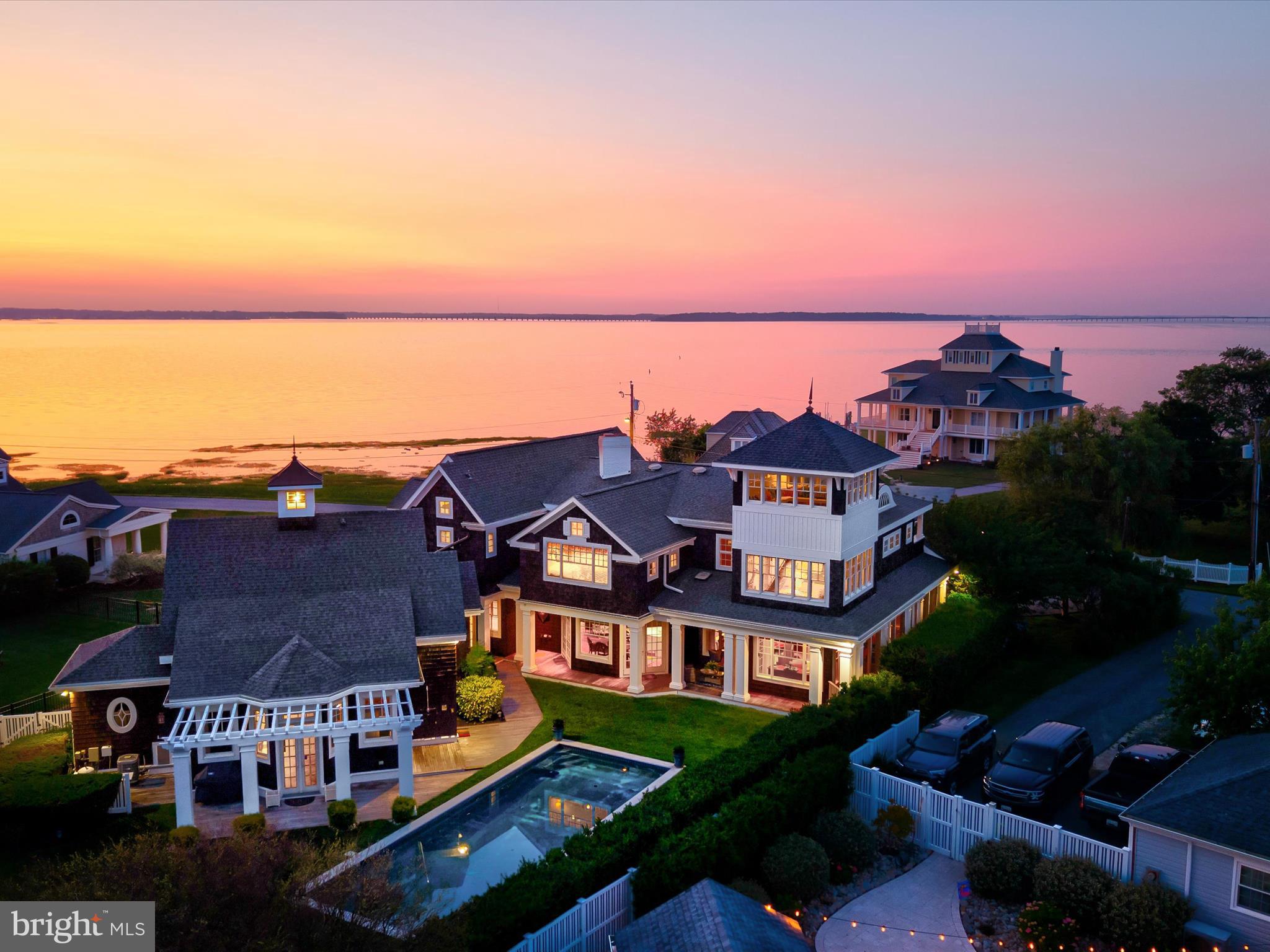 Welcome to the Grand Cottage, a stunning coastal retreat nestled in the heart of Ocean City, Maryland. This exceptional home boasts unique architecture and top-tier features, perfectly harmonizing with its serene setting overlooking the bay. With its unrivaled combination of stylish design and luxurious amenities, the Grand Cottage stands out as a true gem in one of America's most beloved beach towns.

The Grand Cottage captivates with its seamless integration of indoor and outdoor living spaces. Expansive windows frame breathtaking views of the water, ensuring that the soothing coastal environment is always within reach. The meticulous attention to detail is evident throughout, from the beautifully stained front and side doors to the elegant glass kitchen cabinets that reflect the charm of this exceptional home.

This residence has undergone significant upgrades, including a new roof, complete interior repainting, and enhanced landscaping that elevates its curb appeal. The home is equipped with modern conveniences such as new window blinds, carpet stair treads, and a washer/dryer set that complements the stylish mudroom. Each improvement has been made with a commitment to quality, ensuring that the Grand Cottage is both inviting and impeccably maintained.

The heart of the home is the spacious kitchen, designed for both entertaining and intimate gatherings. Open to the living area, it offers unobstructed views of the pool, making it an ideal spot for family and friends. The expansive side porch and the enchanting sunset porch invite you to unwind while watching the sun dip below the horizon, creating a picturesque backdrop for any occasion. The third-floor "thankful tower" offers a 360-degree view that is a true crowd-pleaser. Whether it's the stunning skyline of Ocean City or the excitement of fireworks displays, this observation point provides one of the best seats in town.

In addition to its vibrant communal spaces, the Grand Cottage is also a haven for relaxation and solitude. Numerous hideaway spots are thoughtfully integrated throughout the home, providing tranquil retreats for anyone seeking a moment of peace. Cozy nooks, sunlit corners, and serene reading areas invite you to escape with a book or simply enjoy the calming sounds of nature. The well-designed layout ensures that even when the home is bustling with family and friends, there are plenty of secluded spaces to recharge and reflect.

The outdoor amenities are equally impressive, featuring a saltwater heated pool and a stylish cabana room for ultimate relaxation. The side “crab deck” porch is perfect for hosting large meals and savoring the finest Maryland seafood, making gatherings a delightful experience.

Situated approximately 13 miles along the beautiful Atlantic Ocean, the Grand Cottage is surrounded by a vibrant community filled with entertainment options for all ages. From exquisite dining to convenient shopping, everything you need is just moments away. This luxurious home is more than just a property; it's a lifestyle. With its captivating design, impressive features, and prime location, the Grand Cottage is the ideal sanctuary for family and friends. Experience the joy of coastal living—this is a turn-key opportunity you won't want to miss!