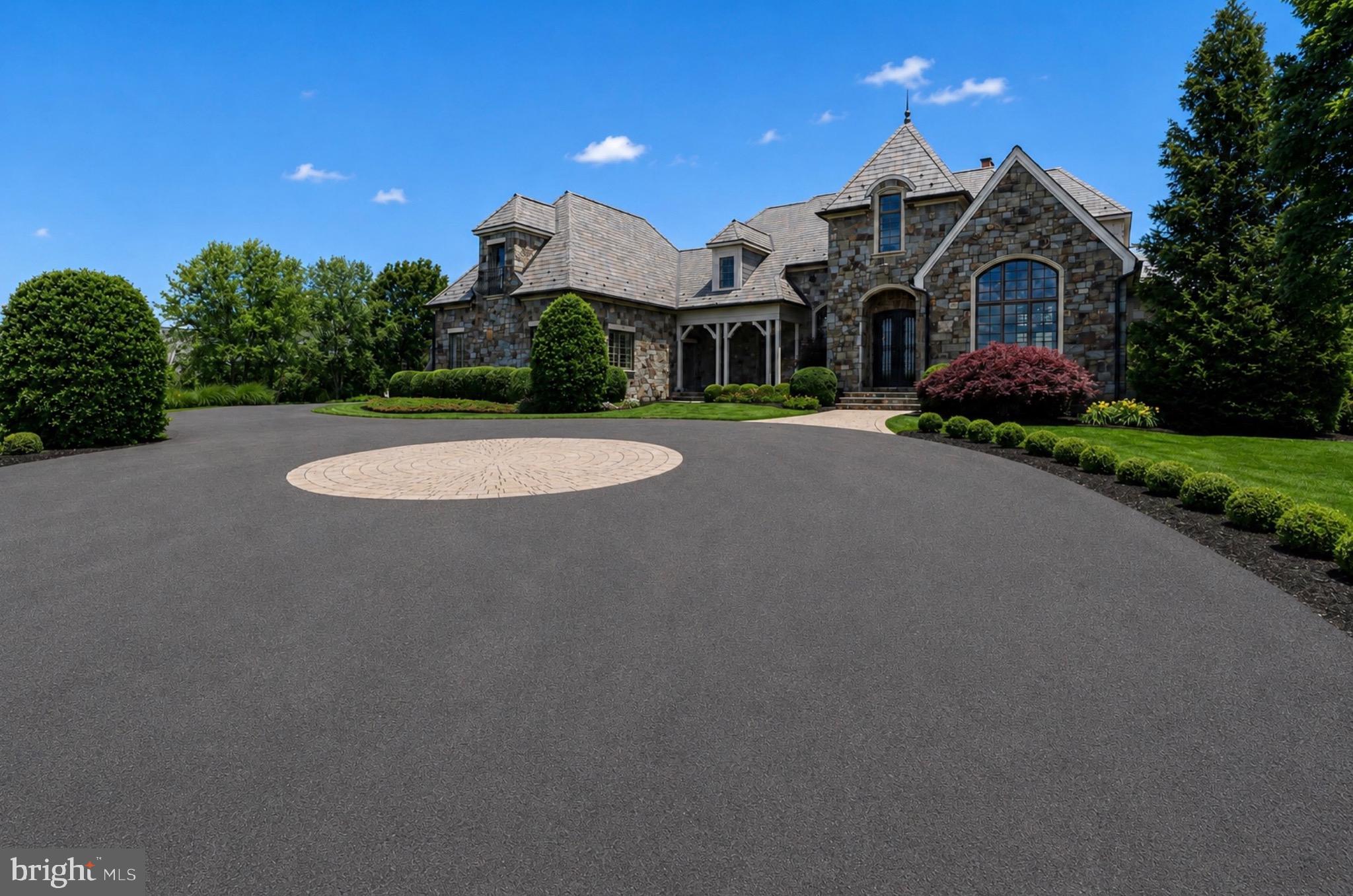 Will Thomas Presents an exceptional lakefront estate on 3.19 private acres within the gates of Creighton Farms in Leesburg. Inspired by the timeless elegance of a French Country manor with English Tudor influences, this custom residence offers 4 bedrooms, 4 full baths, and 1 half bath, including an extraordinary main-level primary suite and a second upper-level suite that lives like an additional primary retreat. Overlooking a fully stocked lake with sweeping sunset views, the home enjoys a setting of remarkable beauty and privacy, complete with a private dock for direct access to the water. Available for immediate occupancy, the home offers an exceptional opportunity to enjoy the remainder of the summer on the lake.

Designed for effortless main-level living, the primary suite is among the home’s defining features. In addition to a recently renovated spa bath with heated floors and a steam shower, the suite offers a truly luxurious dressing experience with two exceptional walk-in closets. The original oversized walk-in closet is complemented by a newly created custom dressing room with floor-to-ceiling cabinetry, providing an extraordinary amount of storage and organization rarely found, even in homes at this price point. Upstairs, a generously proportioned guest suite offers the comfort and privacy of a second primary bedroom, making it ideal for extended family, long-term guests, or multigenerational living.

The interiors were thoughtfully refined in collaboration with renowned designer Barry Dixon, resulting in a sophisticated collection of bespoke finishes throughout much of the main level. Highlights include custom wall coverings, tailored draperies and hardware, a built-in family room banquette, and a dramatic two-story fireplace that serves as the architectural centerpiece of the living room.

Additional highlights include a slate roof, recently replaced HVAC systems, a newly paved driveway and motor court, new exterior lighting, substantial perimeter fencing with 6x6 posts, a whole-house generator, a Control4 smart home system for lighting, televisions, and audio, a whole-house water monitoring system, extensive landscape lighting, and a Gladiator garage storage system.

The unfinished lower level currently provides exceptional storage while offering outstanding potential for future living and entertaining spaces, allowing you to tailor the home to your lifestyle.

Creighton Farms has long been recognized for its rare balance of accessibility and tranquility. Just minutes from Dulles International Airport and the conveniences of Northern Virginia, the community offers an exceptional sense of privacy, security, and serenity from the moment you pass through the gates. For many residents, life extends well beyond the home, with the club serving as the social heart of the community through championship golf, tennis, fine dining, fitness, wellness, and year-round social events.