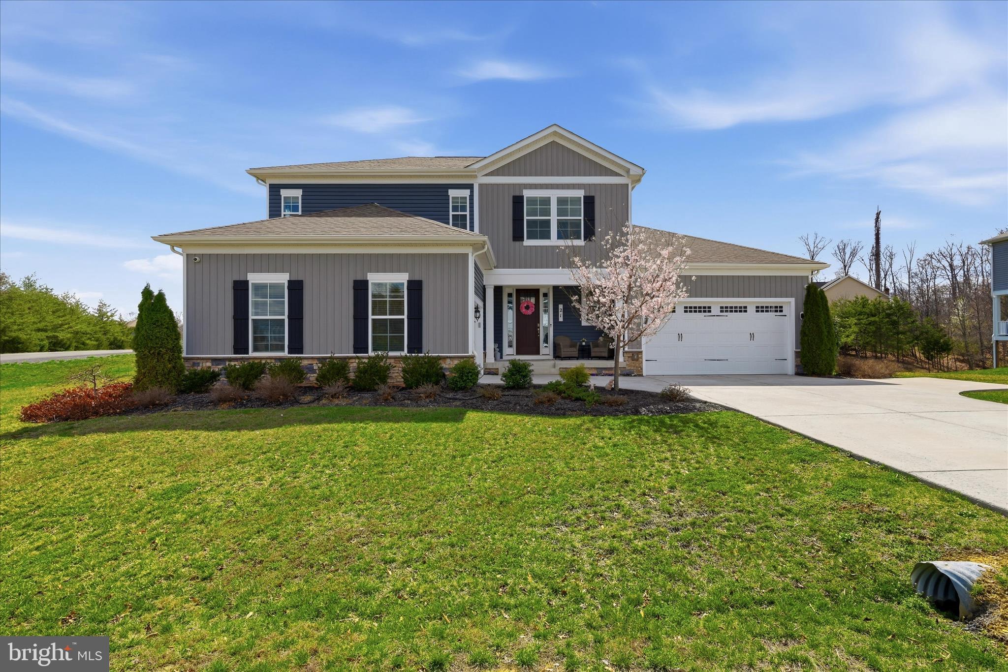 Originally the builder’s showcase model home, this exceptional luxury residence offers over 4,500 finished square feet filled with high-end upgrades, custom finishes, and thoughtful design throughout. Perfectly positioned on a premium .48-acre corner lot in the highly sought-after Blue Ridge Shadows golf course community adjacent to Hole #4, the property offers enhanced privacy, beautiful curb appeal, mountain views, and an unbeatable setting.

Designed with both elegance and functionality in mind, this home features the highly coveted layout today’s buyers are searching for — THREE PRIVATE BEDROOM SUITES, including a luxurious main-level Owner’s Suite and an additional main-level bedroom and full bath, creating the perfect setup for multi-generational living, long-term guests, or private accommodations without stairs.

The spacious Owner’s Suite serves as a true retreat with generous proportions, spa-like comfort, and easy main-level access. A second main-level bedroom offers incredible flexibility for aging parents, guests, or a private home office with nearby full bath access.

At the heart of the home, the gourmet kitchen and expansive great room were designed for entertaining on every level. Features include quartz countertops, upgraded cabinetry, custom pantry, designer lighting, oversized gathering spaces, and beautiful custom finishes throughout. Shiplap accents, feature walls, custom paint selections, and elevated designer touches create warmth and character rarely found in newer construction.

Upstairs, two additional oversized bedrooms each feature their own PRIVATE EN-SUITE FULL BATHROOM and large walk-in closet, offering exceptional privacy and comfort for family or guests. The loft area separating the suites creates the perfect flex space for a home office, reading lounge, playroom, study area, or secondary living space.

The finished lower level adds even more versatility with a large recreation room, additional bedroom, full bathroom, and built-in cabinetry, making it ideal for extended stays, entertaining, hobbies, gaming, or private guest quarters.

Additional highlights include a rare and highly functional garage configuration with an attached 2-car garage PLUS a separate 1-car garage — perfect for extra vehicles, golf cart storage, workshop space, home gym equipment, or additional storage needs.

The home also features a grand foyer, mudroom, main-level laundry, 5 bedrooms, and 5 full bathrooms, all thoughtfully laid out with exceptional flow and livability.

Step outside to enjoy the spacious Trex deck overlooking the fully fenced backyard with beautiful mountain views — the perfect outdoor setting for relaxing evenings, entertaining guests, pets, or outdoor gatherings. Professional landscaping and carefully curated exterior details complete this truly one-of-a-kind showcase home in Blue Ridge Shadows.