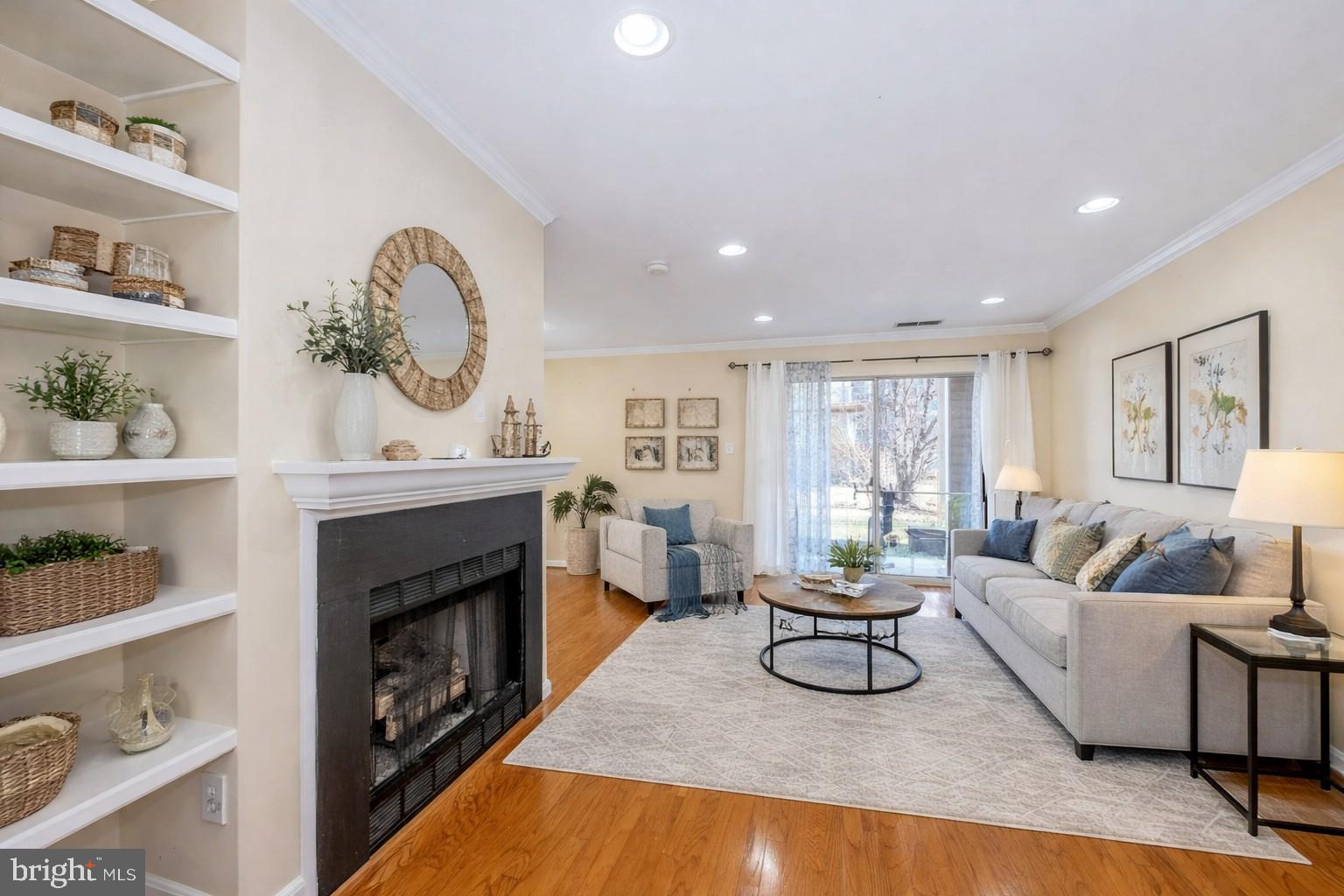 Short Sale Approved! This beautiful move-in ready 1 bedroom, 1 bath condo offers a bright open floor plan with gleaming hardwood floors, crown moldings, custom built-ins, gas fireplace, upgraded recessed lighting, and large windows that fill the space with natural light. The updated kitchen features white cabinetry, granite countertops, tile backsplashes, and stainless-steel appliances. The unit also includes a full-size stackable washer and dryer for added convenience. The spacious bedroom boasts plush carpeting, 3 closets with mirrored doors and custom organizer and access to the well-appointed full bath with a granite topped vanity and tub/shower with spa toned tile.  Enjoy lush and peaceful views of the pond and fountain from your private rear patio. Ideally located with easy access to Dulles Airport and the Ashburn Metro Station. The Ashburn Village Sports Pavilion is right next door, offering incredible amenities including indoor and outdoor pools, tennis courts (domed in winter), racquetball, indoor basketball courts, and a full fitness center. Residents can also enjoy scenic walking and biking trails that wind around the lakes and throughout the community. One reserved parking space is included directly in front of the building, with plenty of additional guest parking available. It’s the perfect home in a stellar location! The first four photos contain virtual staging.