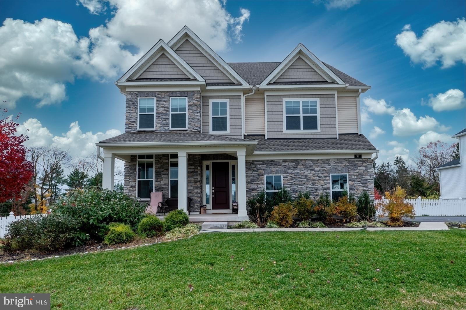 Welcome to the coveted Kimberton Glen neighborhood in the fantastic town of Phoenixville! Ideally positioned on a quiet cul-de-sac, this stunning 4 bedroom 3 1/2 bath home sits on one of the very best lots in the development, offering a private, fully fenced backyard and a warm, inviting presence from the moment you arrive. The charming covered front porch and upgraded front door with sidelights set the tone for the high-end finishes found throughout. Step into the foyer and to your left, you’ll find the formal living room—perfect for entertaining or quiet relaxation. Continue straight into the heart of the home: an incredible open-concept gourmet kitchen that will take your breath away. Designed with upgraded appliances, gorgeous white quartz countertops with dramatic black veining, an exquisite custom backsplash, and an oversized island with striking black-and-gold veined quartz, this kitchen is truly a showstopper. The island comfortably seats five and includes a farmhouse sink, while a massive walk-in pantry provides exceptional storage. The kitchen flows seamlessly into the adjoining family room and dining room, where oversized windows bathe the space in natural light. Sliding glass doors lead to a large composite deck with stairs down to the private backyard—an ideal setup for indoor-outdoor living and summer gatherings. A powder room, mudroom, and access to the two-car garage complete the main level. The first floor shines with 10-foot ceilings, 8-foot doorways, upgraded recessed lighting, and wide plank LVP flooring throughout. Head up the beautiful hardwood staircase to the second floor, where you’ll find an impressive layout designed for comfort and convenience. The enormous primary suite features dual walk-in closets and a luxurious en-suite bath with double sinks, a private toilet room with bidet, and a spectacular oversized shower with bench. A generously sized princess suite with walk-in closet and a beautifully appointed full bath is perfect for guests or family. Down the hall is a spacious linen closet, a large hall bath with double sinks and a soaking tub, and two additional oversized bedrooms, each with their own walk-in closets. A roomy second-floor laundry adds everyday ease. The upper level includes upgraded carpeting and recessed lighting throughout. But there’s even more! The fully finished basement offers wide plank LVP flooring, full-size windows for great natural light, and recessed lighting—creating a versatile space perfect for recreation, a home gym, media room, or additional living area. All of this is just minutes to downtown Phoenixville, Owen J. Roberts Schools, Phoenixville Hospital, and major commuter routes. This exceptional home combines luxury, comfort, and location—a truly perfect place to call home!