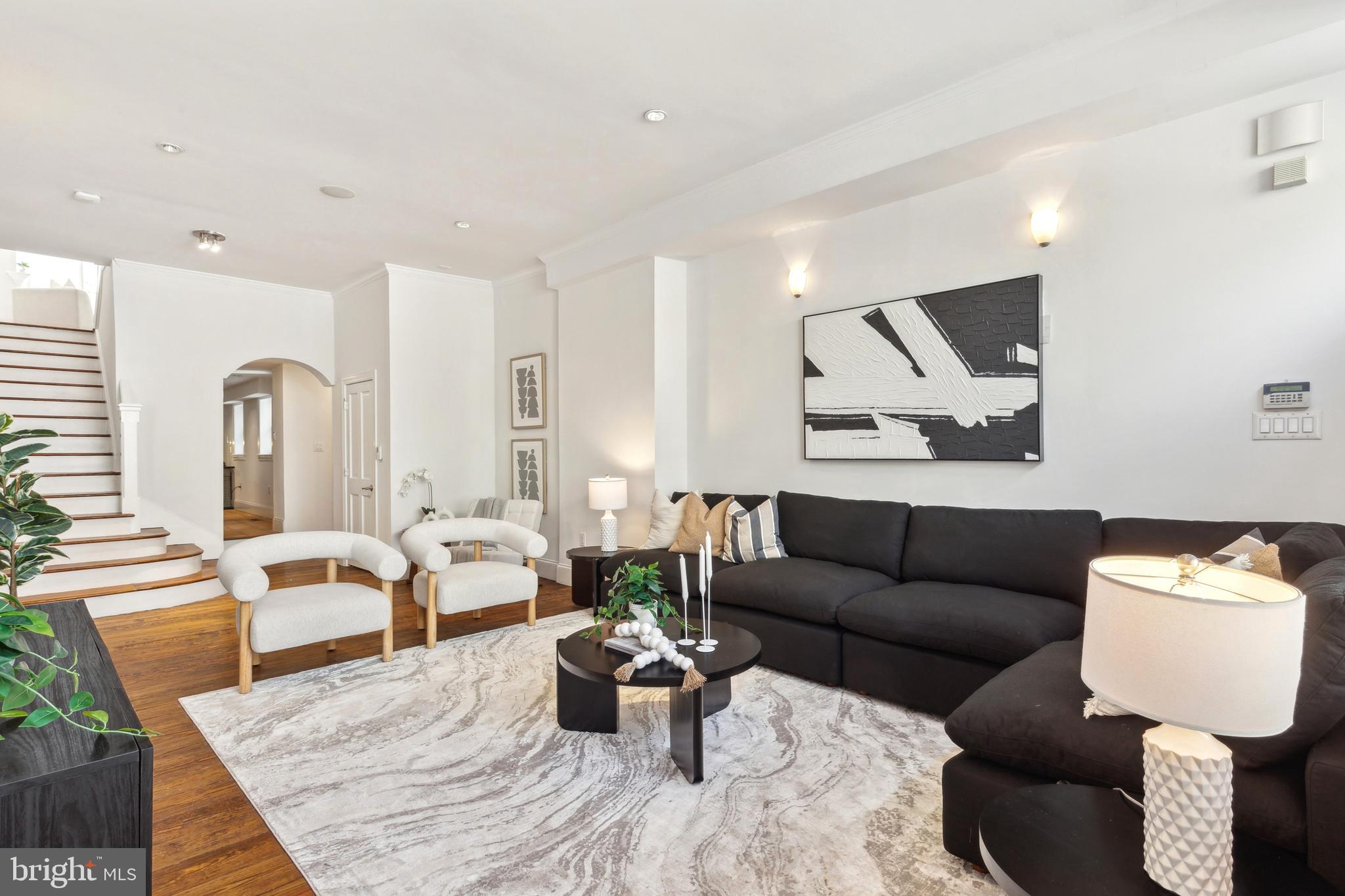 Incredible opportunity to own a historic home, designed for entertaining! Located on a prime block in Washington Square West, this former store front was converted and fully restored in 2003. Currently configured as a 2 bedroom + den home, this property features high ceilings, wide-plank hardwood floors, crown molding, preserved fireplaces, recessed lighting, and more. The 1st floor living room is graciously proportioned, and leads to the formal dining area and open kitchen featuring custom-built wood cabinetry, stainless steel appliances, and good counter space. Stairs to the 2nd floor lead to the open den/sitting area with skylight, that could easily be converted into a 3rd bedroom. The 2nd floor primary suite is spacious with good closet space, and an ensuite custom tiled bathroom with roman-style sunken bath and shower. The light-filled 3rd floor bedroom suite showcases a vaulted ceiling, mosaic-tiled full bath with glass shower, and access to the large private rear deck. A full partially-finished basement houses the washer and dryer, and provides great additional storage space. Perfectly situated in Washington Square West, this home is just steps away from the best of neighborhood cafes, fine dining, boutique shopping, neighborhood parks, and more. Whole Foods, Jefferson Hospital, Pennsylvania Hospital, Avenue of the Arts, Midtown Village, and the Broad St Line are all just minutes away!