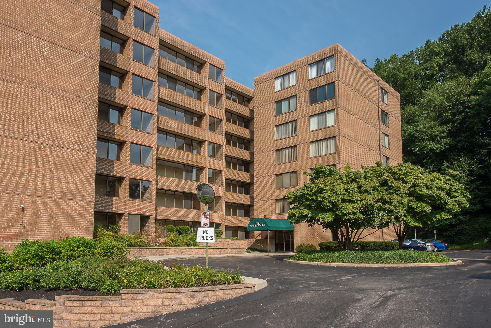 Welcome to Unit 1-G at the Greenhouse Condominium, ideally situated in the highly desirable Bala Cynwyd community. Nestled within a serene, park-like setting featuring mature trees, lush landscaping, and a tranquil stream, this move-in ready 2-bedroom, 2-bath residence offers the perfect blend of comfort, convenience, and natural beauty. This first-floor unit provides easy, stair-free access and features a bright, open-concept living and dining area filled with natural light and peaceful views. Sliding glass doors lead to a spacious enclosed patio overlooking a wooded area and creek—an ideal setting for relaxing or entertaining. The eat-in kitchen offers ample cabinet and counter space, perfect for everyday living. The primary suite boasts generous closet space and a private ensuite bath complete with tub, vanity, and tile flooring. A well-sized second bedroom offers flexibility for guests, a home office, or additional living space. Additional highlights include two large hall closets, a full hall bathroom, and a convenient in-unit laundry closet. The unit also comes with one deeded parking space located close to the building for added ease. Residents of Greenhouse Condominium enjoy access to a community outdoor pool, enhancing the lifestyle experience during warmer months. Ideally located just minutes from the Cynwyd Heritage Trail, Center City, Manayunk, and major roadways including I-76, and situated within the award-winning Lower Merion School District, this is a wonderful place to call home. Please note that The Green House is a no-pet community.