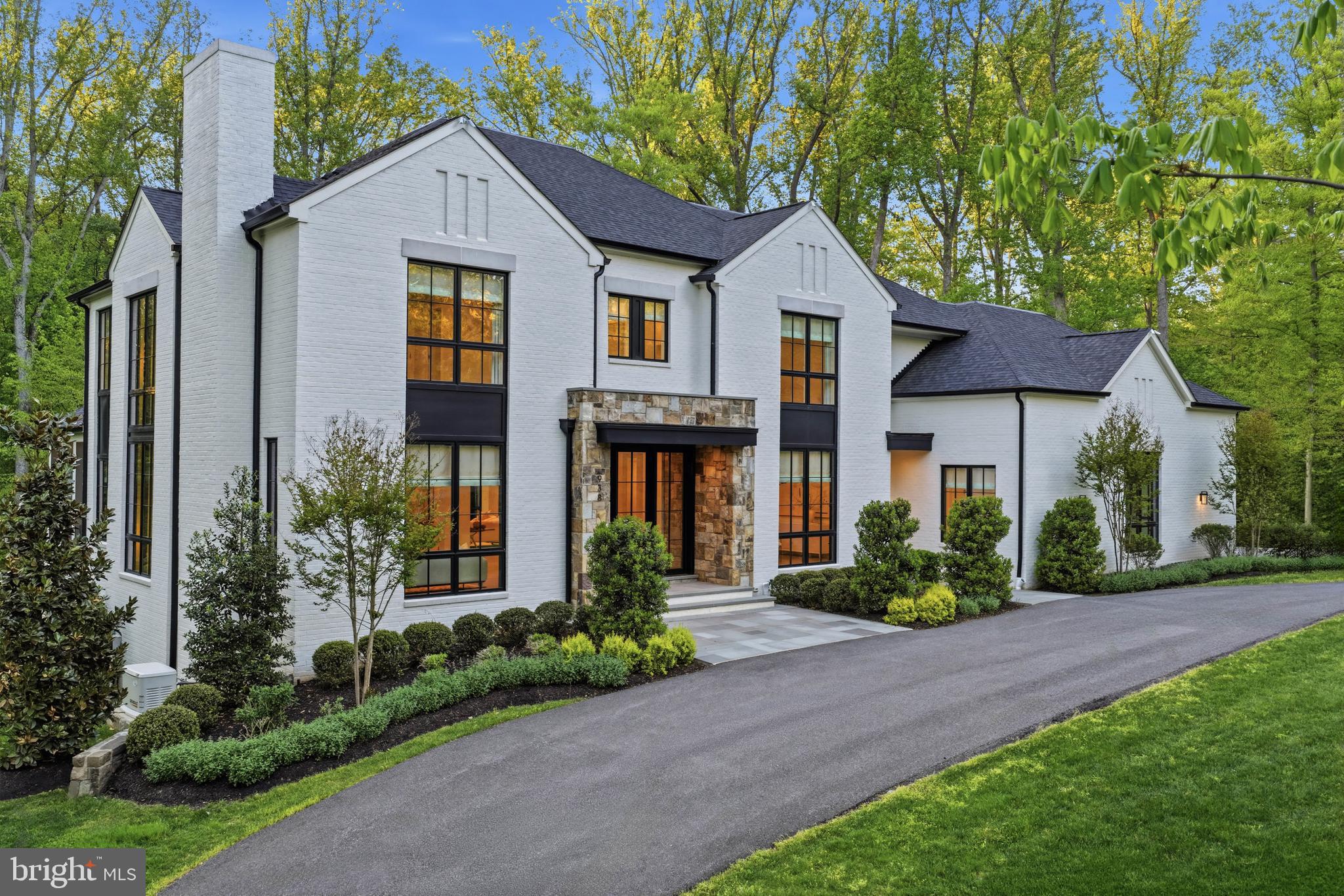 JOIN US FOR AN OPEN HOUSE- THIS SUNDAY 2/7 from 2-4! Rare Opportunity to see this one of a kind Luxury Home.  Beautifully sited on 1.4 private acres, this extraordinary custom residence offers over 10,000 square feet of refined living and a sophisticated blend of soft contemporary and transitional design. Walls of glass and soaring ceilings fill the home with natural light, while exceptional finishes and meticulous craftsmanship define every space.
A dramatic foyer introduces the main level, flanked by elegant formal living and dining rooms. The expansive family room—anchored by a striking two-sided fireplace shared with a private office—opens seamlessly to a screened porch and a rear terrace spanning the width of the home, creating effortless indoor-outdoor living. A richly appointed library with floor-to-ceiling built-ins provides a quiet retreat. The gourmet kitchen is impeccably designed with top-of-the-line Thermador appliances, including separate 36" refrigerator and freezer, a quartz waterfall island, and a fully customized beverage center with integrated filtration and sparkling water. 2 staircases and an elevator to all levels makes for easy accessibility.
Upstairs, the luxurious primary suite is a true sanctuary, featuring volume ceilings, tranquil views, and a fireplace. The spa-inspired bath offers an oversized steam shower, soaking tub, dual walnut vanities, and three custom walk-in closets. Three additional bedrooms, each with en-suite baths and walk-in closets, complete the upper level.
The walk-out lower level is designed for exceptional entertaining, featuring a professionally designed home theater, custom bar with reclaimed wood accents, and a Full Swing golf simulator with integrated swing analysis. Additional highlights include a wine cellar, guest suite with en-suite bath, two full baths, a secondary laundry area, and abundant storage.
Thoughtfully enhanced with over $1 Million in post-purchase improvements, the home also includes an elevator, generator, irrigation system, and a three-car side-load garage.
Experience the next level of smart living with seamless Josh AI voice control, Control4-powered throughout the home. Effortlessly manage lighting, window blinds and curtains, climate, entertainment, and security with intuitive, natural voice commands tailored to your lifestyle. This sophisticated integration offers both convenience and privacy, delivering a truly personalized and responsive home environment. Elevate everyday living with cutting-edge technology designed for comfort, efficiency, and modern luxury.
The outdoor spaces are equally compelling, with expanded grounds that include a circular fire pit patio with built-in seating and audio, a water feature, and multiple areas for dining and lounging. The screened porch is fully equipped with heaters, a ceiling fan, and outdoor media for year-round enjoyment, while a walk-out patio off the kitchen offers a complete grilling and dining experience.
A rare offering in one of McLean’s most convenient and accessible neighborhoods, this residence delivers a seamless blend of timeless architecture, modern technology, and elevated luxury living.