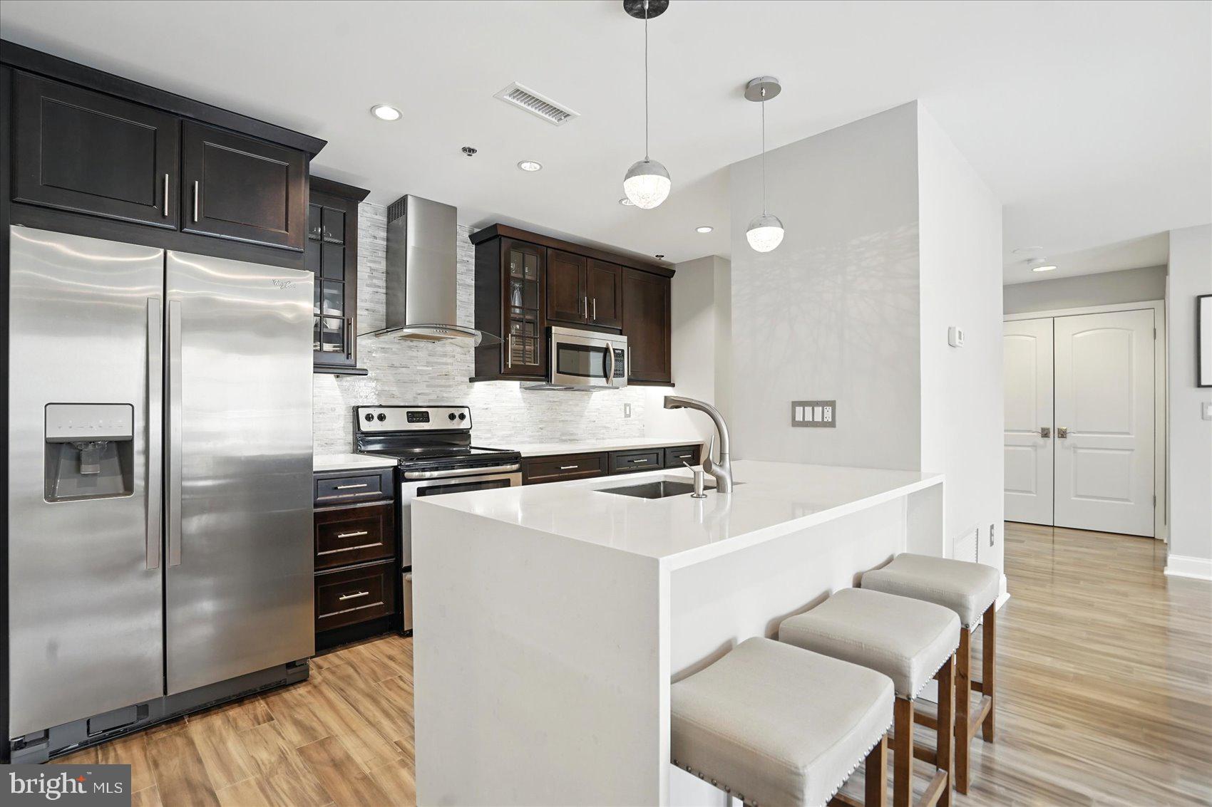 Looking for resort style living in the heart of Canton? This extremely sought-after gated condo community on the Canton waterfront is what you've been looking for! This gorgeous top floor unit features two bedrooms, two full baths and is filled with natural light, an open floor plan and ample outdoor space. Nearly every square inch of the unit has been meticulously updated, including beautiful quartz kitchen countertops with waterfall edge, under cabinet lighting, imported marble primary bath with custom glass enclosure, a custom stone fireplace in the living room, and more. Located within a short drive of local amenities as well as major arteries including I-95, 895 and 83. You are also within walking distance to some of Baltimore's best local restaurants, bars, grocery stores, athletic clubs, a swim club and shops which are located right outside your secure door. This stellar water-front building features a fitness center in the garage and 24-hour security. The unit comes with a deeded garage parking spot in addition to ample street parking. The unit also currently holds a second rental parking spot which the new owner could potentially take over for a monthly fee. Don't miss this one!