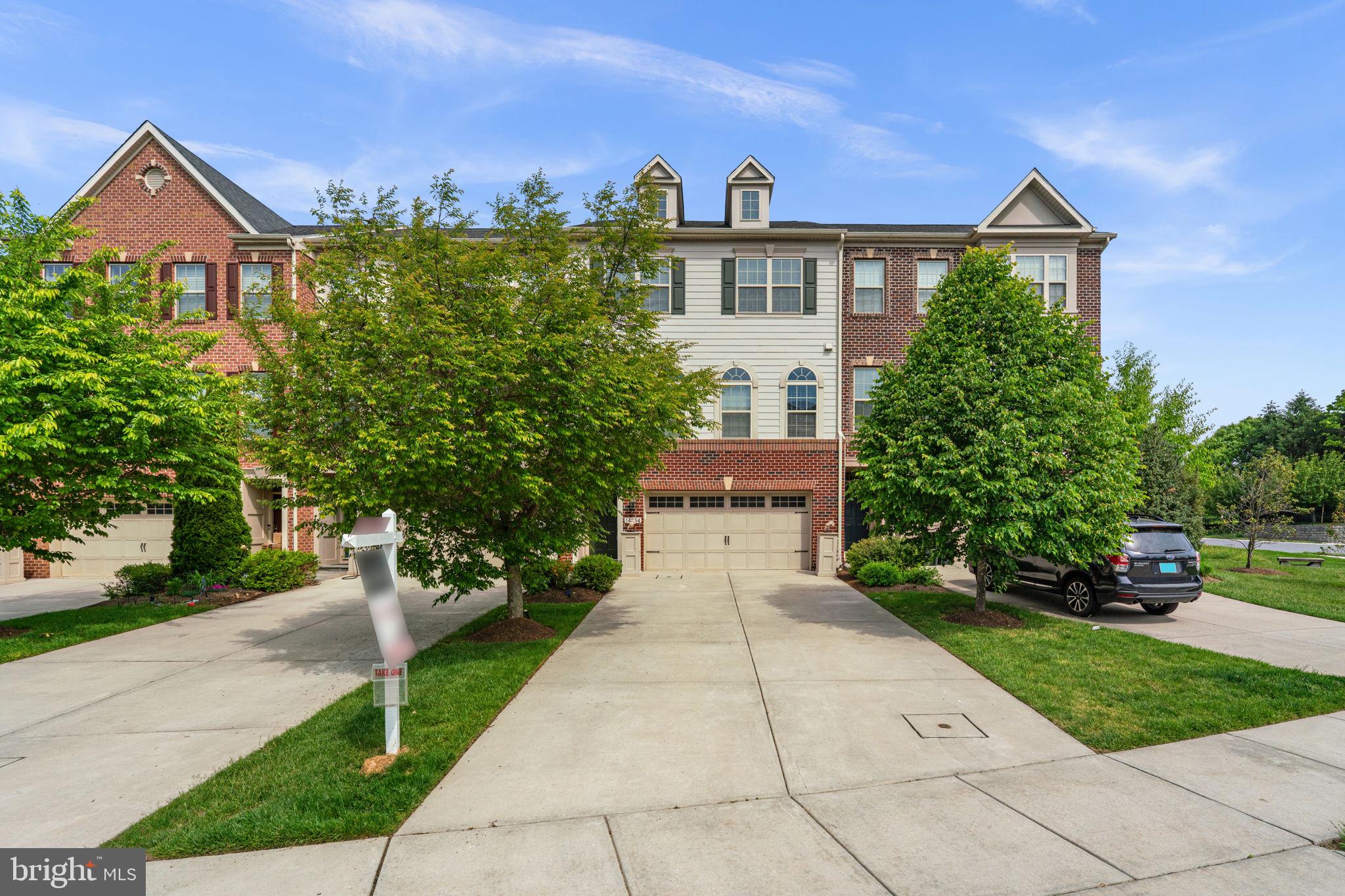 Elegant Colonial-style townhouse nestled in desirable Hunt Valley Overlook, offering 3 bedrooms, 3.5 bathrooms, and 2,664 finished square feet filled with stylish finishes and spacious living areas. Additional modern features include smart switches, a smart thermostat, Ring cameras, and a Tesla charger for added convenience and contemporary living. // Step inside the welcoming foyer and ascend to the open-concept main level, where gleaming hardwood floors flow throughout the sun-filled living room featuring an eye-catching accent wall and access to the elevated deck. // The beautifully appointed eat-in kitchen showcases granite countertops, a pantry, oversized center island with breakfast bar seating and pendant lighting, custom tile backsplash, and stainless steel appliances, blending both elegance and functionality. // The adjoining dining room is enhanced with a chair railing, lower wainscoting, charming arched windows, and a convenient powder room nearby, creating an ideal layout for entertaining and everyday living alike. // Upstairs, the serene primary suite features hardwood flooring, a spacious walk-in closet, and a private ensuite bath complete with a corner soaking tub, separate shower, and dual vanities. Two additional bedrooms with hardwood floors—including one accented with decorative wainscoting—share another full bathroom, while a convenient laundry closet completes the upper level. // The walk-out lower level offers an expansive recreation room with plush carpeting and an additional full bathroom, providing excellent flexibility for lounging, entertaining, or guest accommodations. // Outdoor living is equally inviting with an elevated deck featuring a privacy wall, a covered lower patio with charming swings, and a two-car attached garage for added convenience and storage.