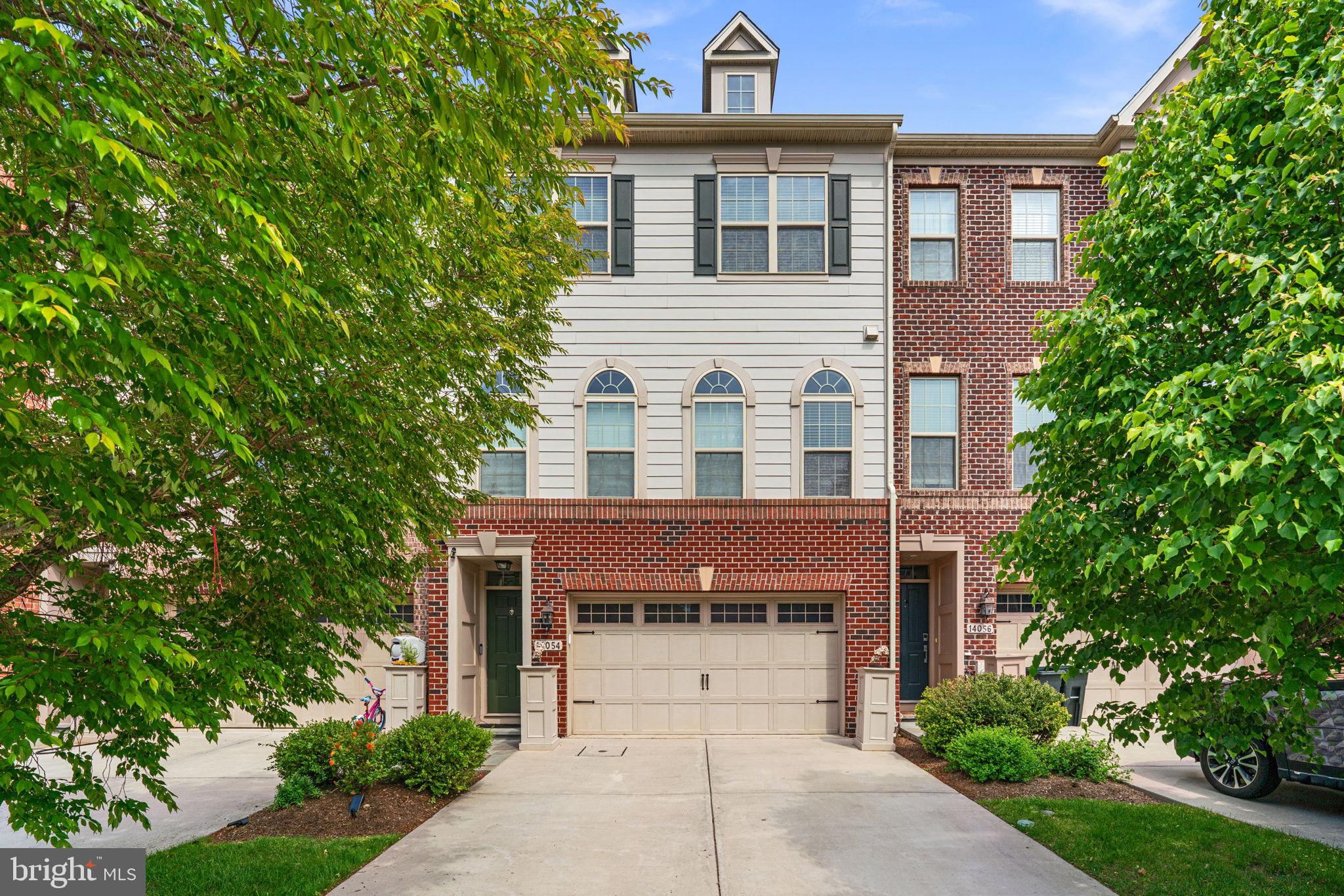 Elegant Colonial-style townhouse nestled in desirable Hunt Valley Overlook, offering 3 bedrooms, 3.5 bathrooms, and 2,664 finished square feet filled with stylish finishes and spacious living areas. Additional modern features include smart switches, a smart thermostat, Ring cameras, and a Tesla charger for added convenience and contemporary living. // Step inside the welcoming foyer and ascend to the open-concept main level, where gleaming hardwood floors flow throughout the sun-filled living room featuring an eye-catching accent wall and access to the elevated deck. // The beautifully appointed eat-in kitchen showcases granite countertops, a pantry, oversized center island with breakfast bar seating and pendant lighting, custom tile backsplash, and stainless steel appliances, blending both elegance and functionality. // The adjoining dining room is enhanced with a chair railing, lower wainscoting, charming arched windows, and a convenient powder room nearby, creating an ideal layout for entertaining and everyday living alike. // Upstairs, the serene primary suite features hardwood flooring, a spacious walk-in closet, and a private ensuite bath complete with a corner soaking tub, separate shower, and dual vanities. Two additional bedrooms with hardwood floors—including one accented with decorative wainscoting—share another full bathroom, while a convenient laundry closet completes the upper level. // The walk-out lower level offers an expansive recreation room with plush carpeting and an additional full bathroom, providing excellent flexibility for lounging, entertaining, or guest accommodations. // Outdoor living is equally inviting with an elevated deck featuring a privacy wall, a covered lower patio with charming swings, and a two-car attached garage for added convenience and storage.