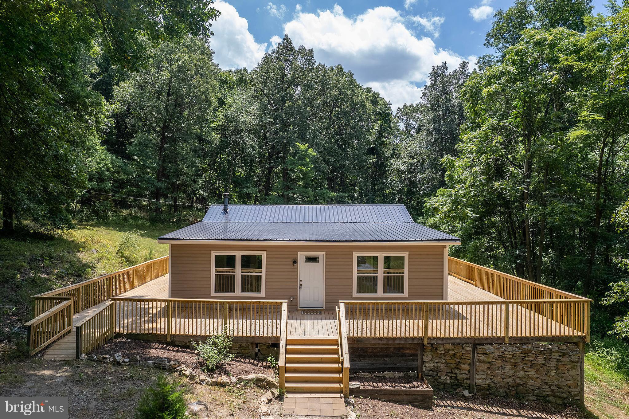 SECLUSION, PRIVACY, CONVENIENCE.  IF THESE ARE TERMS DESCRIBING YOUR SEARCH, THEN LOOK NO FURTHER.  THIS RECENTLY REMODELED HOME IS SITUATED IN THE WEST VIRGINIA HILLS WITHIN A 40 MINUTE DRIVE OF I-81 AT WINCHESTER, VA .  WHETHER LOOKING FOR A MOUNTAIN RETREAT, OR A PERMANENT PLACE TO CALL HOME, THIS PROPERTY WILL MEET THE NEEDS OF ANY AND ALL SEARCHING FOR A PEACEFUL EXISTENCE.  THE OPEN CONCEPT INTERIOR WITH MODERN FINISHING PROVIDES SPACIOUS LIVING AND NEW, LOW MAINTENANCE FEATURES.  THE ENORMOUS WRAP AROUND DECK SUPPLIES AN OUTDOOR SPACE TO RELAX AND ENJOY THE THE TYPE OF SCENIC BEAUTY THAT ONLY THE MOUNTAIN STATE CAN OFFER.  WITH THIS ONE YOU WILL BE GETTING A BIG BANG FOR YOUR BUCK!  DON'T HESITATE, OR IT MAY BE GONE BEFORE YOU KNOW IT!