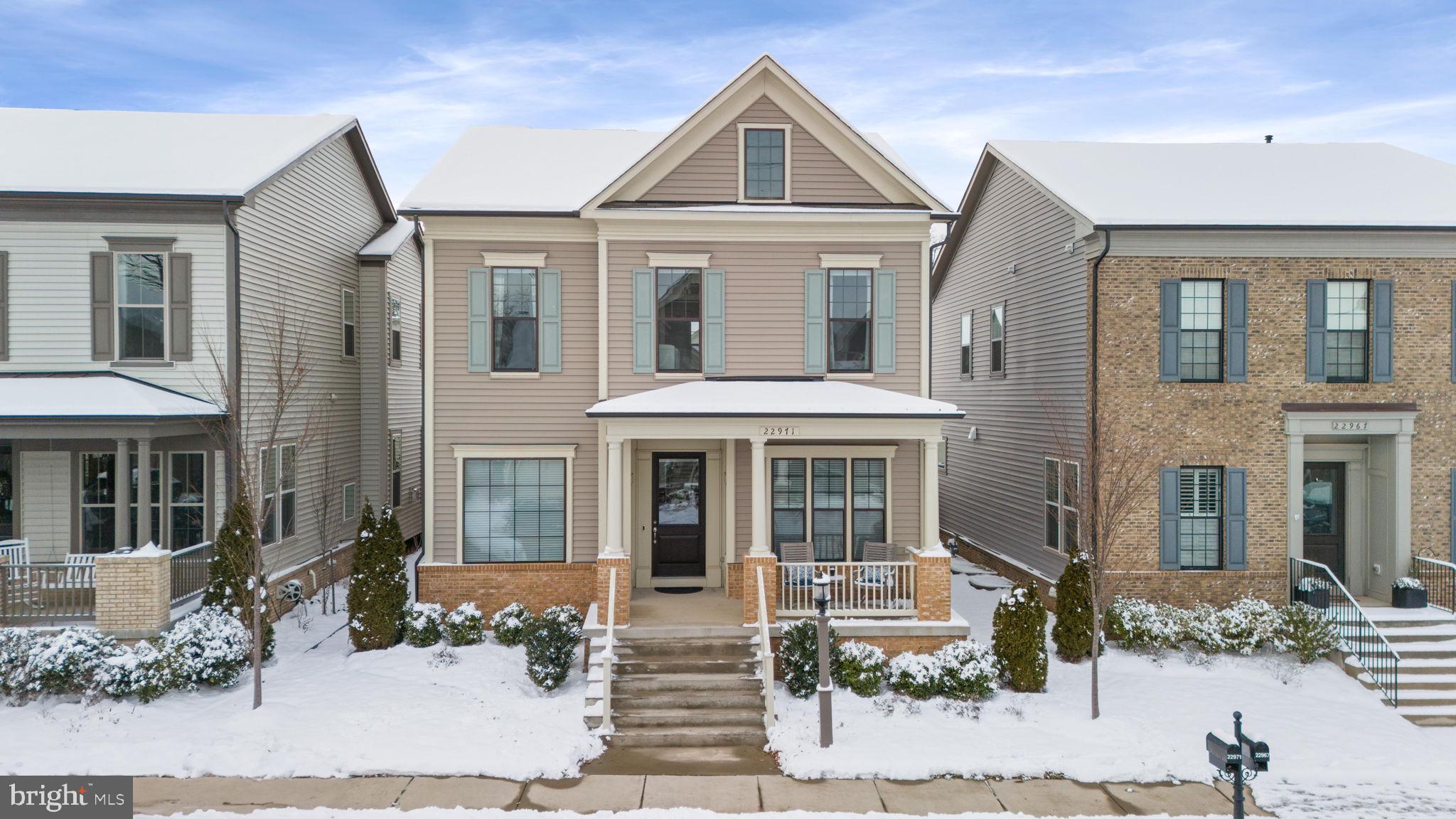 Welcome Home!  This sleek 2018 Miller and Smith home boasts every upgrade you could want all in the heart of Brambleton.  Before entering, have a seat on the expansive full front porch and take in a sunset view.  Once entering the foyer, you'll first notice the ten foot ceilings and upgraded crown moldings as you pass the large home office on your right and dedicated dining room on your left.  Alternatively, park in the rear private garage with EV charger and leave the day's stress behind you in the family entry area with built in bench and storage system. Your main floor features a  huge gourmet kitchen with bright cabinetry and oversized island, custom hood, stainless steel appliances, walk in pantry storage,  a butler's pantry with wine refrigerator, breakfast area, and open concept living into the family room. The family room includes a fireplace with views of the private backyard, complete with custom patio, Trex deck, and green space. Make your way up the staircase to an upper level full of space and style. Brand new wide plank flooring continues throughout. Pass the upper level laundry room on your way to the double door entry owner's suite, with feature wall, oversized custom walk in closet, a spa bathroom with two vanities, expansive frameless walk in shower, and separate water closet. Three additional bedrooms and a full bath are upstairs as well. The best is saved for last with your fully finished basement, which includes a fifth bedroom and adjacent bathroom, a family media and game room, a home gym space, and huge storage space!  This gorgeous property feels like a model home and boasts luxury living at its best right in the heart of Loudoun County! Its location offers a lifestyle of sophistication and convenience with nearby shopping, dining, recreation and more! Just a few blocks away to Loudoun County Parkway & Greenway/Toll Road. Close proximity to INOVA, Dulles International Airport, Brambleton Town Center, One Loudoun, Dulles Landing. Just a few miles to future silver line Ashburn Station Metro. Even walk to top rated Loudoun County Public Schools! This beautifully maintained and expertly designed home is a true gem you won't want to miss!