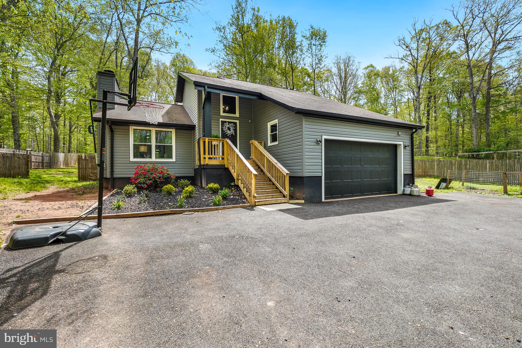 This home has been tastefully remodeled over the past 5 years.  New Roof in 2020, updated septic in 2022, pumped and replaced floaters and sensors.  New HVAC and Heat Pump in 20222, The Screened in Porch was bult in 2023, ideal for use three seasons.  All New Siding, Windows, Doors and Gutters replaced in 2023 including Garage Door.  The driveway was paved in 2023.  Gorgeous Chef's Kitchen with New Cabinets, New Quartz and New Stainless High End Appliances including a Wine Fridge were added in 2024.  Main Floor Bathrooms were both gutted and remodeled in 2024.  Outside Stamped Concrete installed 2024.  Numerous Trees were taken down to open the back yard.  New Buyer will enjoy the Hot Tub which was installed in 2024.  New Hot water heater 2024.  Amazing amount of upgrades in the past 3 years.  Cool Kids Family Hangout outside the Laundry Area, to your left when entering the garage.  Country Living  ten minutes from the VRE.  Convenient for Commuters.  OPEN HOUSE SATURDAY JUNE 6 from 12pm-2pm