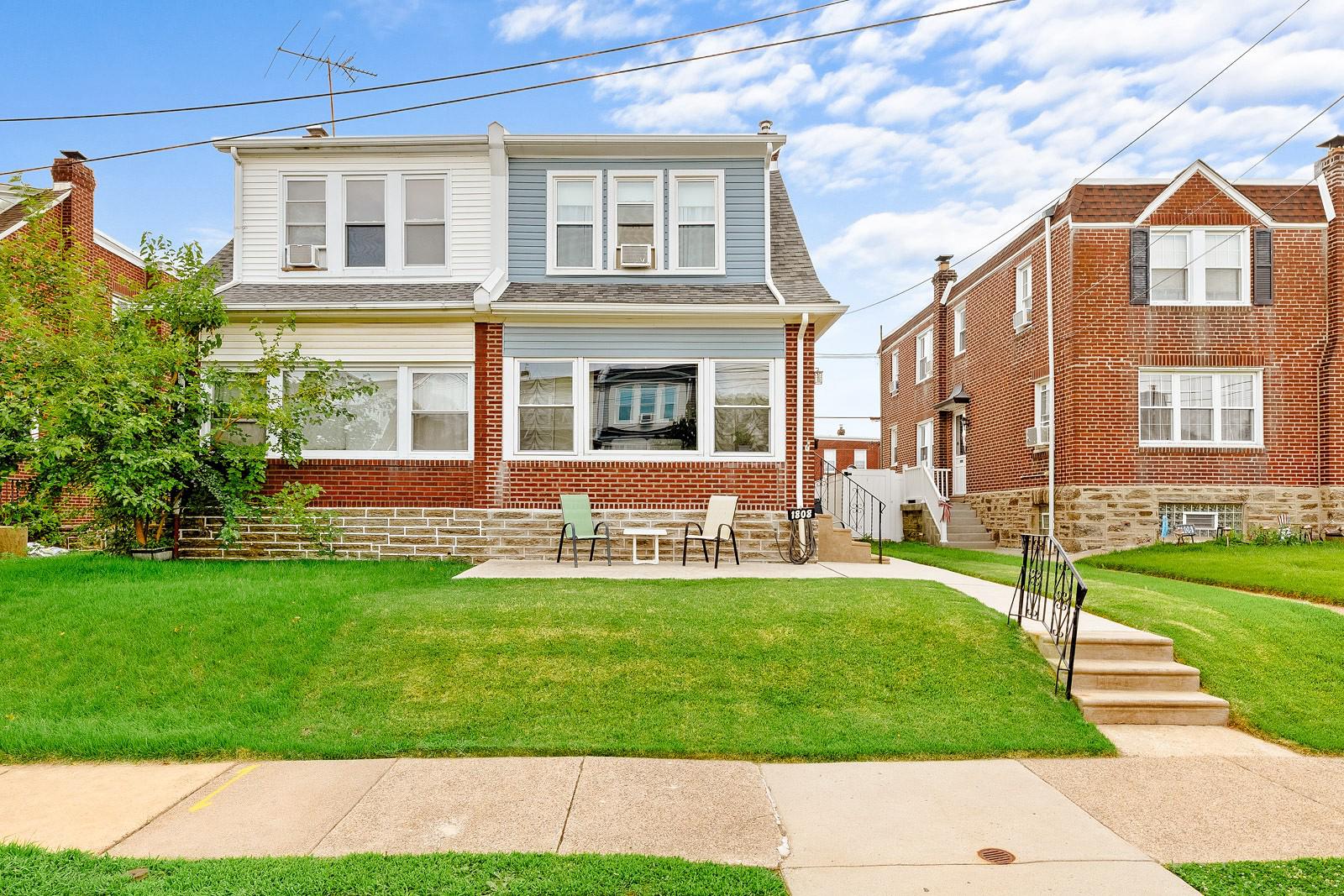 Welcome to this beautifully kept twin in Rhawnhurst.  This home has been well maintained throughout and the pride of ownership shows!  Walk up and see the beautiful CURB APPEAL with all new updated siding (2022), a nice front lawn, a large front patio, an updated concrete walkway(2020), a brick and stone exterior and a newer front entry door.  Walk into the living room which has LOTS of windows, beautiful hard wood floors and neutral paint throughout.  There is a large dining room off the living room with hardwood floors and a BREAKFAST BAR.  There is a NEWER BEAUTIFUL KITCHEN with CORIAN COUNTER TOPS, STAINLESS STEEL APPLIANCES and a DOUBLE GAS OVEN with five burner top, There is a REFRIGERATOR with a Water Dispenser and a built in Ice Maker, a Dishwasher, a garbage disposal, beautiful tile backsplash, TWO Lazy Susans, a Large Pantry with PULL OUT DRAWERS and tons of SLOW CLOSING CABINETS.  Off the kitchen is the back covered porch with a nice size back yard and a fire pit.  There is a storage area under the porch and an EXTRA LARGE 1.5 GARAGE with an electric Garage Door Opener and a side door for access to the yard.  The back yard is fully fenced for privacy.  Upstairs has three NICE SIZE bedrooms, LOTS of windows, hard wood floors throughout and a fully updated bathroom.  The basement has so much space.  There is a large living room, a bonus room (used as a bedroom), a storage room, a laundry room with MAYTAG Washer (2026) and Dryer and a FULL BATHROOM with a shower stall.  There are Bilco doors to the back yard in the laundry room and a newly installed sump pump in the laundry room.  There is a NEWER 200 AMP electric panel (2025).  A new ROOF was installed in 2022.  Come and see this home, it has so much to offer!  You will not be disappointed!