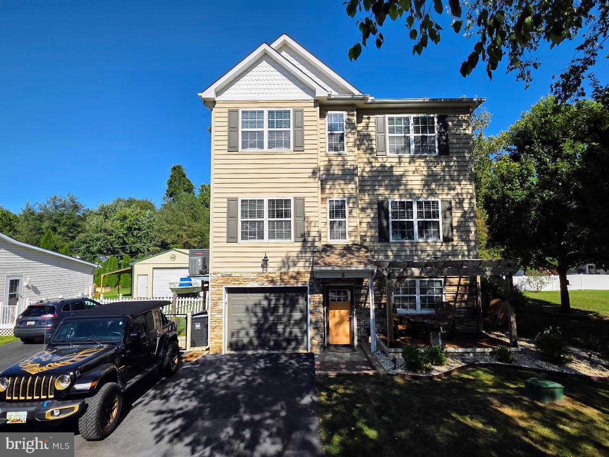 Great New Price! Located in the popular Water Front Community of Locust Point. This 4 Bedroom, 2 1/2 Bath Home has many Amenities & Updates. The Kitchen has upgraded tile Backsplash & Counter Tops with Butcher Block & Granite finish. The large Living Room has a wood Insert in the Fireplace. Also on this Level is a Bedroom . Upstairs are 3 nice size Bedrooms including the Laundry Room. The Primary Bedroom has good size & offers a recently upgraded Private Bathroom. The Lower Level offers a nice Entrance & 2 additional Living Spaces, including the Rec Room & Front Hobby Room. Throughout the Front of the House there are some Views of the Elk River & they only get better with the change of Season. The Garage runs the full length of the House, enabling enough Room for 2 Vehicles.  Outside there is plenty of options to Entertain with a Front Porch, Rear Deck with Awning & Patio. Also included with your Purchase is the Shed, Expanded Driveway, Ring System & built-in Garage Car Charger.  The Property has Deeded Water Rights with a Boat Ramp & Public Marina in the Neighborhood for River & Slip Access. This Home has been truly taken care of & will impressive even the pickiest of Buyer.