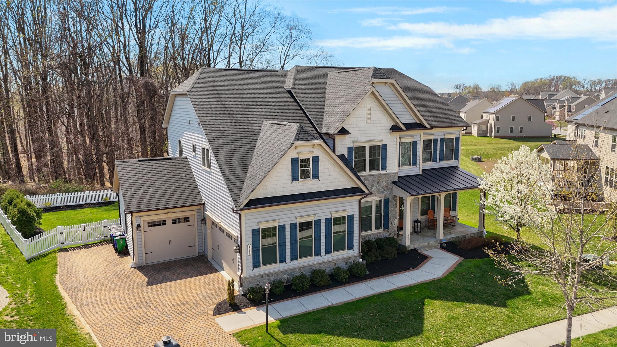 An extraordinary offering in Wincopia Farms, this Chapel Hill model by NV Homes is a masterclass in refined living—where architectural grandeur meets intentional, high-caliber upgrades curated for those who expect nothing less than exceptional. Set on one of the community’s most coveted, tree-lined homesites, the residence unfolds with a commanding stone façade, an extended paver driveway, and an unmistakable sense of arrival. Inside, sun-drenched interiors are framed by soaring ceilings, rich wood flooring, and a seamless, open-concept design that captures both scale and warmth. At the heart of the home, a breathtaking two-story family room commands attention—anchored by a custom floor-to-ceiling fireplace adorned in intricate herringbone tile, flanked by Palladian windows that pour natural light across the space. The adjacent gourmet kitchen is a statement of both function and beauty, featuring 42” dual-toned cabinetry, an expansive island, premium stainless steel appliances, double wall ovens, a gas cooktop with a designer hood, and a fully integrated wet bar with wine refrigeration. Thoughtfully enhanced with hardwired under-cabinet and accent lighting, every detail has been elevated to create an environment equally suited for intimate evenings and grand entertaining. The home’s enhancements extend far beyond the expected—custom built-in closets throughout, newly installed designer lighting and ceiling fans, motorized window treatments with Wi-Fi and remote integration, and a fully redesigned laundry suite with Samsung appliances and bespoke cabinetry. A refined mudroom with added granite surfaces, along with a fully outfitted SimpliSafe security system, ensures both elegance and peace of mind at every turn. Retreat to the upper level, where the owner’s suite offers a private sanctuary defined by tray ceilings, dual walk-in closets, and a spa-caliber bath featuring a frameless body-jet shower, soaking tub, and dual vanities. Secondary bedrooms are generously proportioned, while each bathroom has been completely renovated to reflect modern luxury and cohesive design. The lower level is an entertainer’s dream—featuring a fully equipped wet bar, a media-ready feature wall, a private bedroom suite, and a newly finished office or fitness studio designed for today’s lifestyle. From here, step outside to a meticulously curated outdoor living experience: a custom paver patio with a sitting wall, cedar plank flooring at the walkout, ambient landscape lighting, and a natural gas fire bowl complemented by a built-in Weber grill—creating a setting that is both sophisticated and effortlessly inviting. Wi-Fi controlled string lighting adds an enchanting glow, extending the experience well into the evening. Additional enhancements include epoxy-coated garage floors, overhead storage systems, retractable deck screen door, new microwave and disposal, and a level of finish rarely found even in new construction. Every element has been thoughtfully selected, seamlessly blending luxury, technology, and timeless design. Positioned just minutes from major commuter routes including 29, 32, 95, and Route 216—with easy access to Columbia, Baltimore, Washington, D.C., and Fort Meade—this residence offers both prestige and convenience. Paired with top-ranked Howard County schools and the unparalleled lifestyle of Wincopia Farms, this is more than a home—it is a statement.