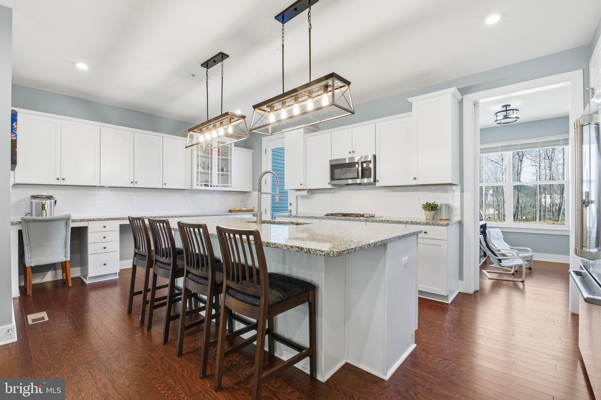 Welcome to this beautiful 4-bedroom, 3.5-bathroom townhouse offering 2,676sqft of beautifully designed living space in the heart of Gambrills, MD. This modern, light-filled home boasts a thoughtfully designed open layout with a perfect blend of functionality and ambiance that makes the home feel incredibly inviting. 
Step inside and be greeted by elegant hardwood floors and recessed lighting that create a warm and inviting ambiance. The spacious living and dining areas feature large windows, allowing an abundance of natural light to flow through. The gourmet kitchen is the heart of the home, complete with granite countertops, a large center island, smart stainless steel appliances, two pantries, soft-closed shaker cabinets, backsplash, and a sunlit breakfast area. Off of the kitchen, you'll find a den/office space, and a deck ready for weekend BBQs. To add convenience, there is another closet and half bathroom on this level.
Upstairs you'll find 3 spacious bedrooms, a convenient laundry room with a sink, and 2 full bathrooms. The owner's suite is your personal retreat, boasting dual walk-in closets, an ensuite bathroom with a separate shower, and a two sink vanity. The fully finished lower level offers a mudroom, coat closet, access to your 2 car garage, and a versatile 4th bedroom with walk-in closet and full bathroom - perfect for guests, a home gym, or a vibrant media/rec room.
What truly sets this home apart is the rare sense of privacy; with no direct neighbors situated in front or behind the property, you can enjoy your private patio and fire pit in peace (you also have the option to fully fence your backyard). The community offers a dog park, playground, green space, and plenty of guest parking.
Located just 2 minutes from Waugh Chapel Towne Centre. Residents enjoy convenient access to great shopping, dining, grocery stores (Wegman's, Fresh Market), fitness studios, and entertainment. Major commuter routes to Fort Meade, Annapolis, Baltimore, and Washington DC. This home offers the perfect balance of a quiet residential retreat and immediate access to everything you need.